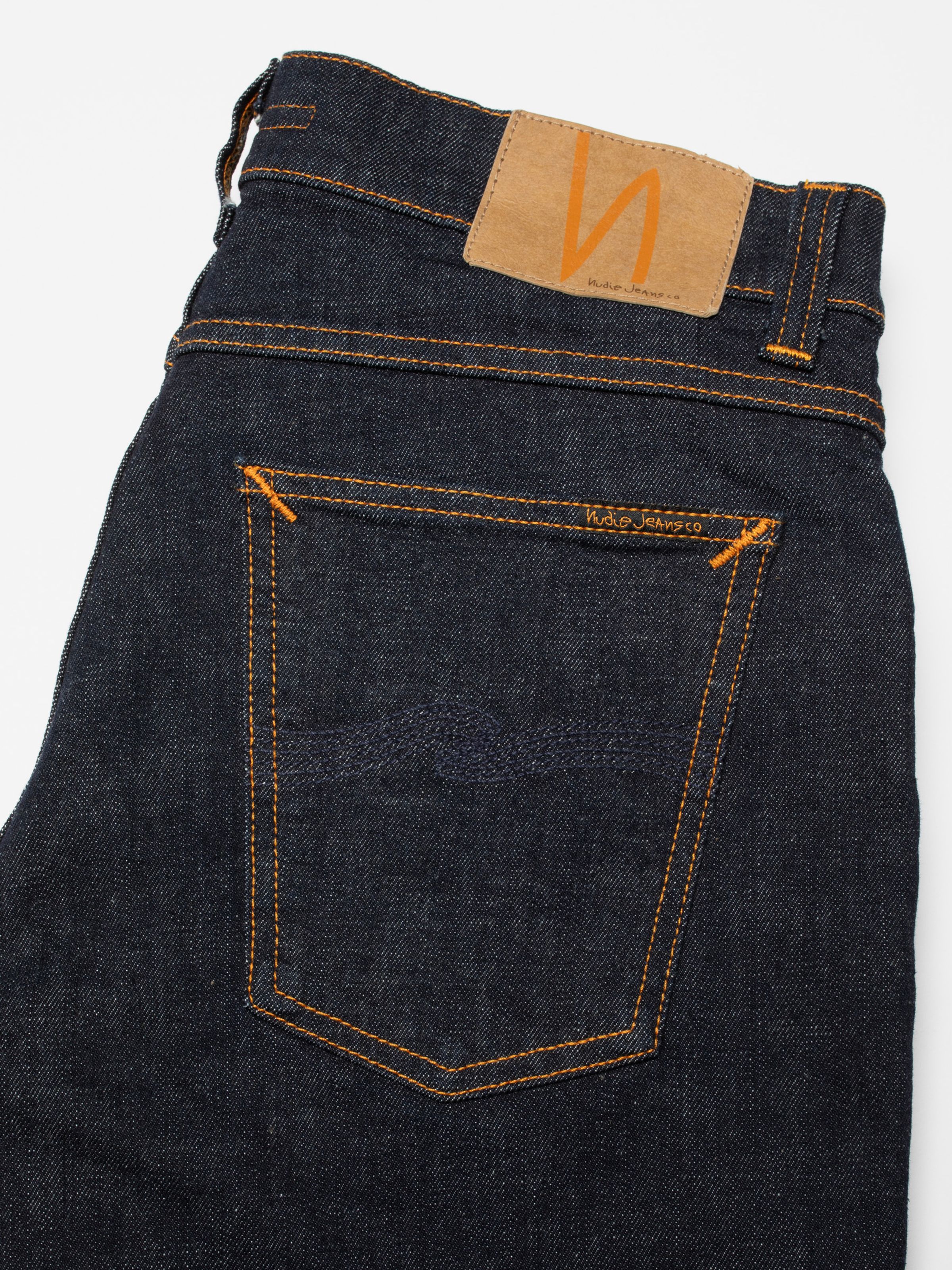 Nudie Jeans Tight Terry Rinse Twill, men's tight fit jeans, showing a close-up of the back pocket and jacron patch.