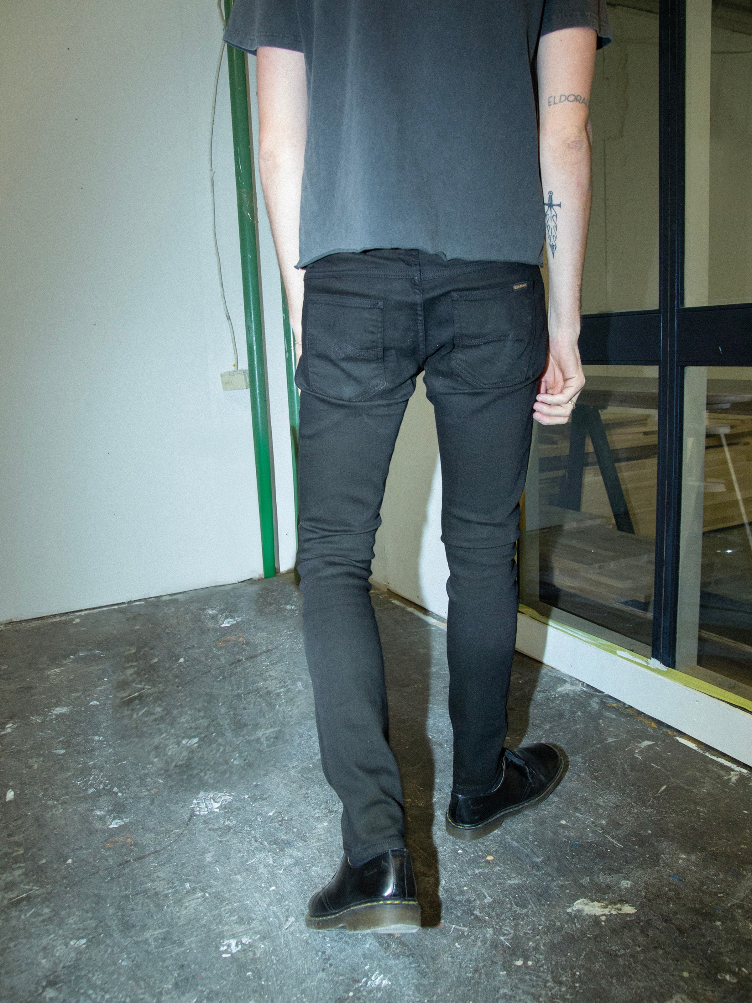 Nudie Jeans Tight Terry Everblack, men's tight fit jeans shown from the back on a model.