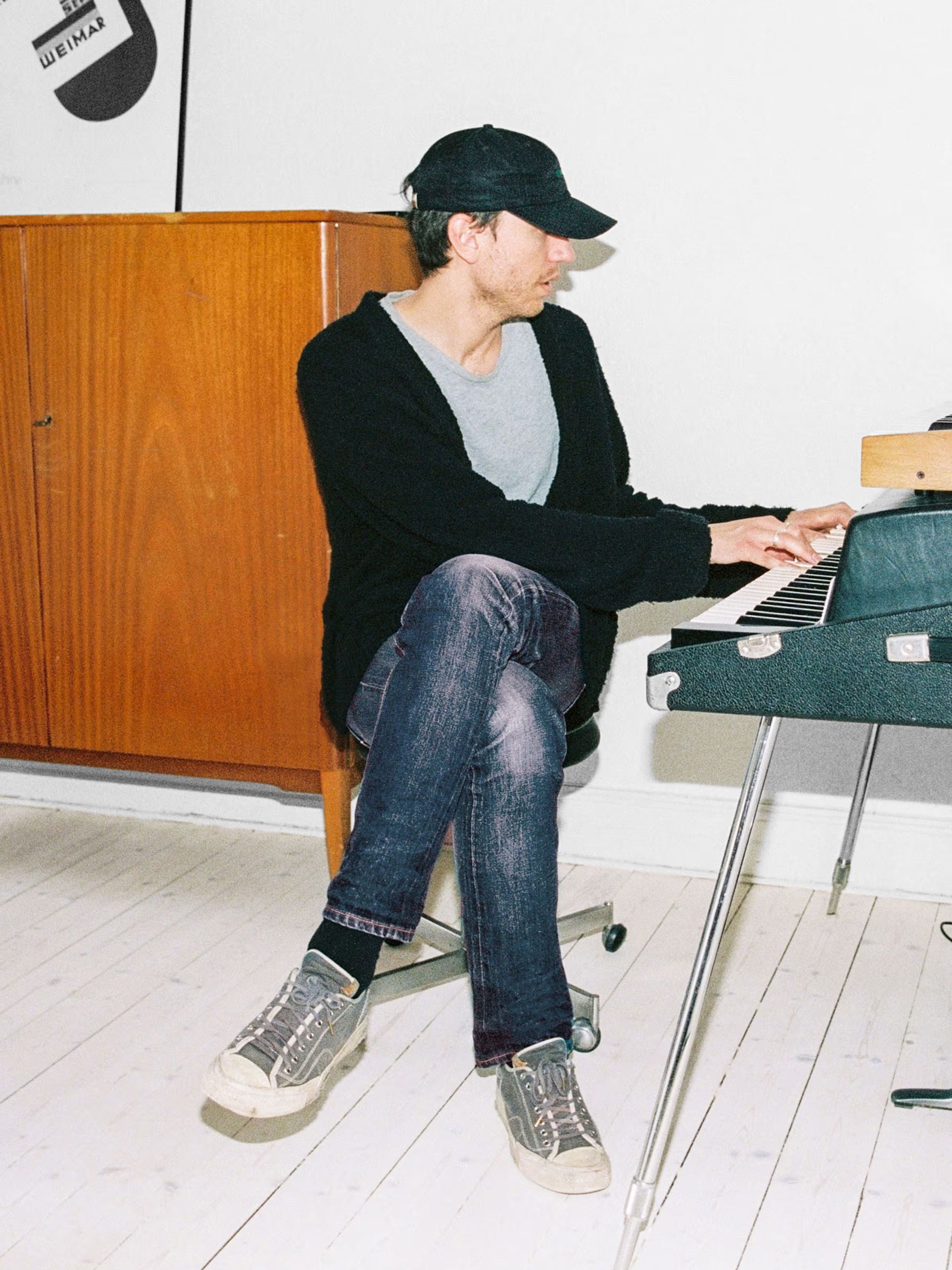 Nudie Jeans Steady Eddie II Dry Selvage, regular tapered jeans in dry blue selvedge denim worn playing an electric piano.