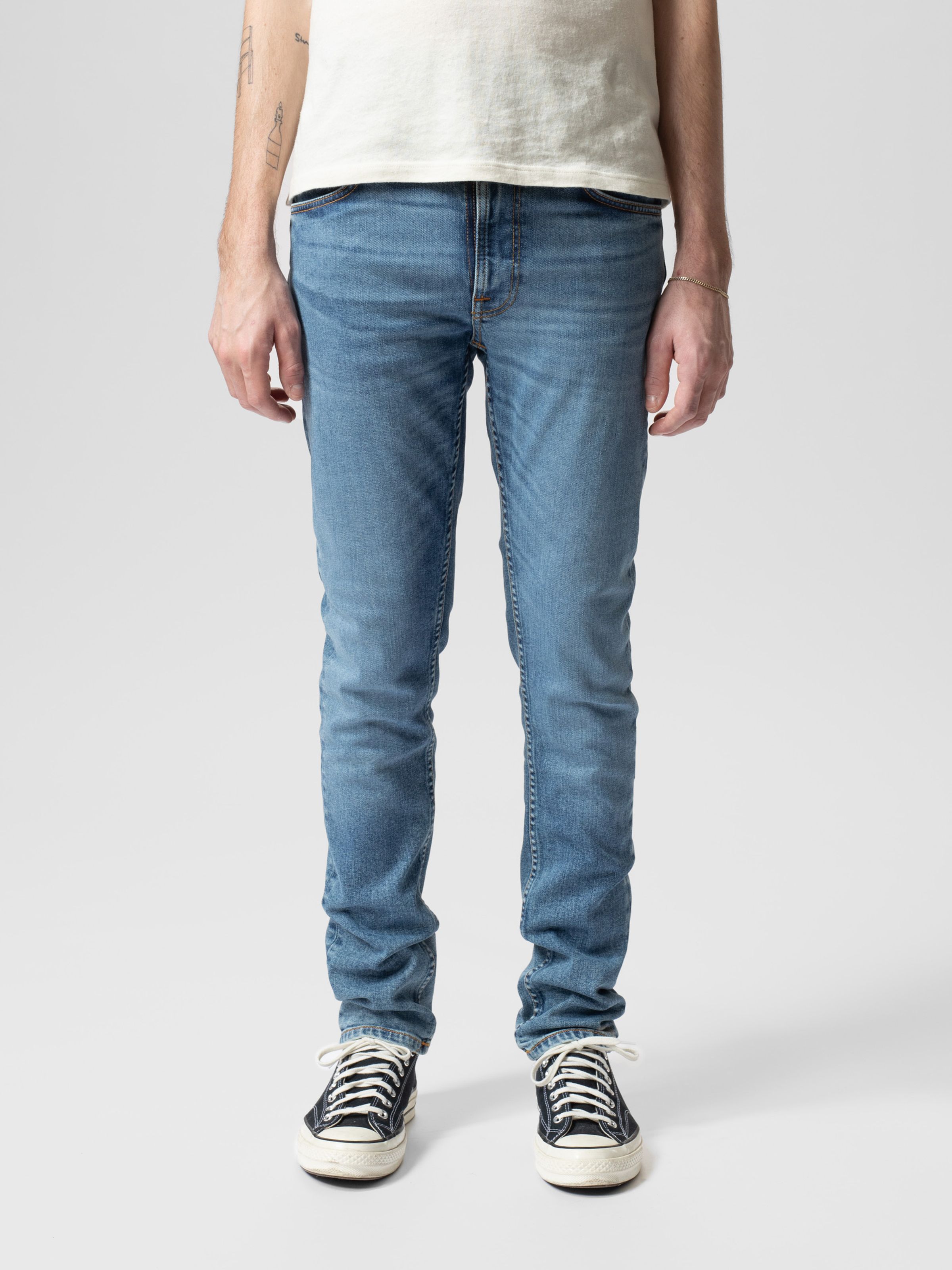 Nudie Jeans Lean Dean in Lost Orange, a men's slim tapered fit jean in a mid-blue wash, shown from the front on a model.
