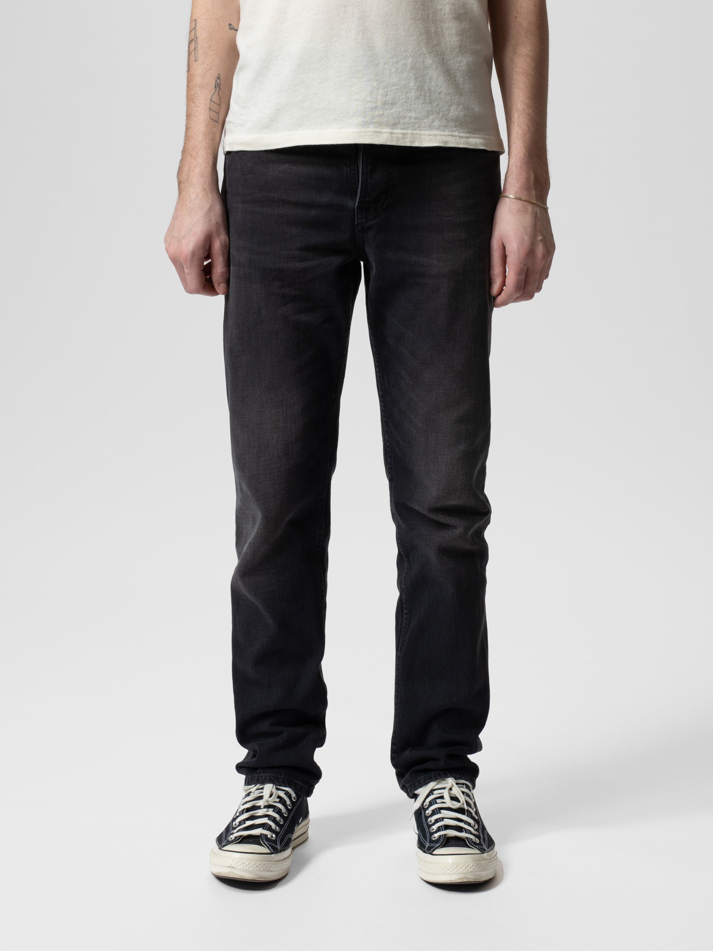 Nudie Jeans Steady Eddie II in Black Change, men's regular tapered fit jeans shown from the front on a model.