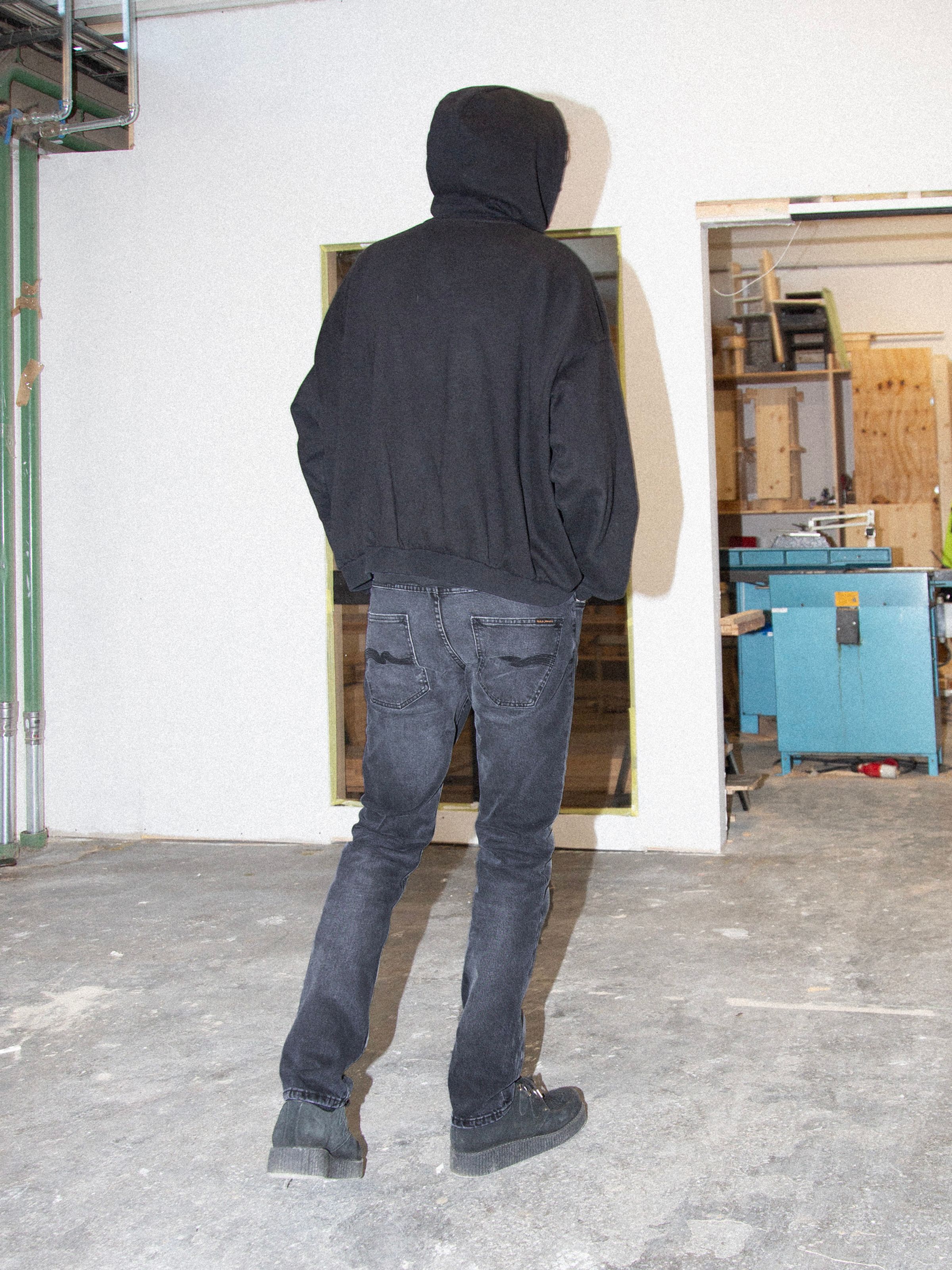 Nudie Jeans Grim Tim Dark Cove, men's slim straight jeans shown from the back on a model.