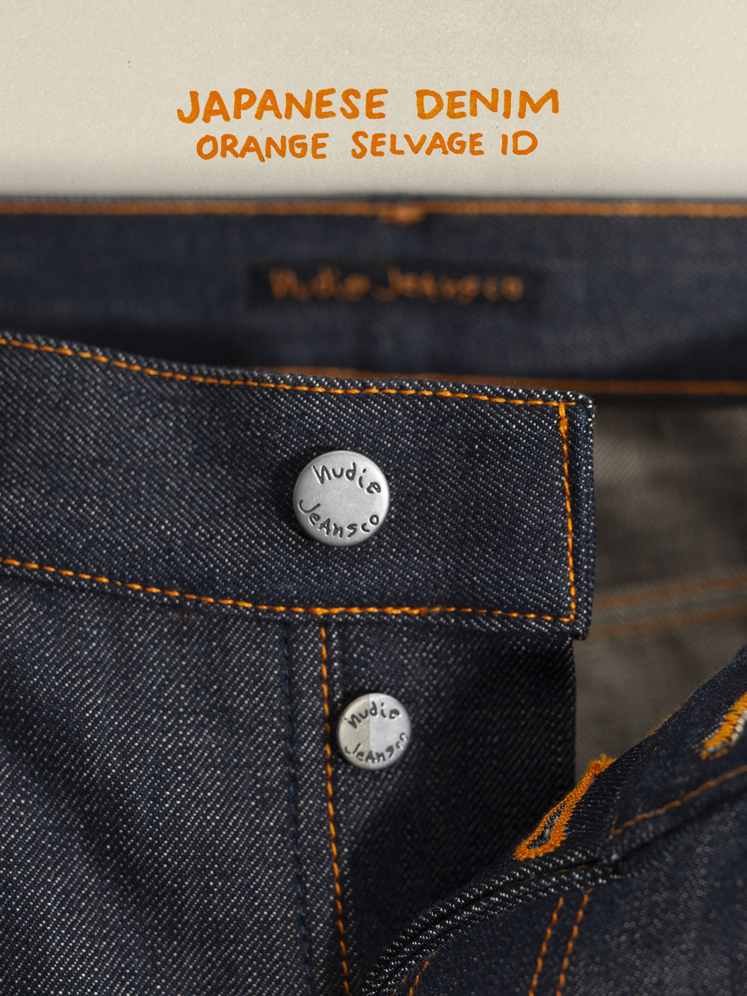 Nudie Jeans Tuff Tony Dry Selvedge, showing a close-up of the button fly, antique silver trims, and orange stitching.