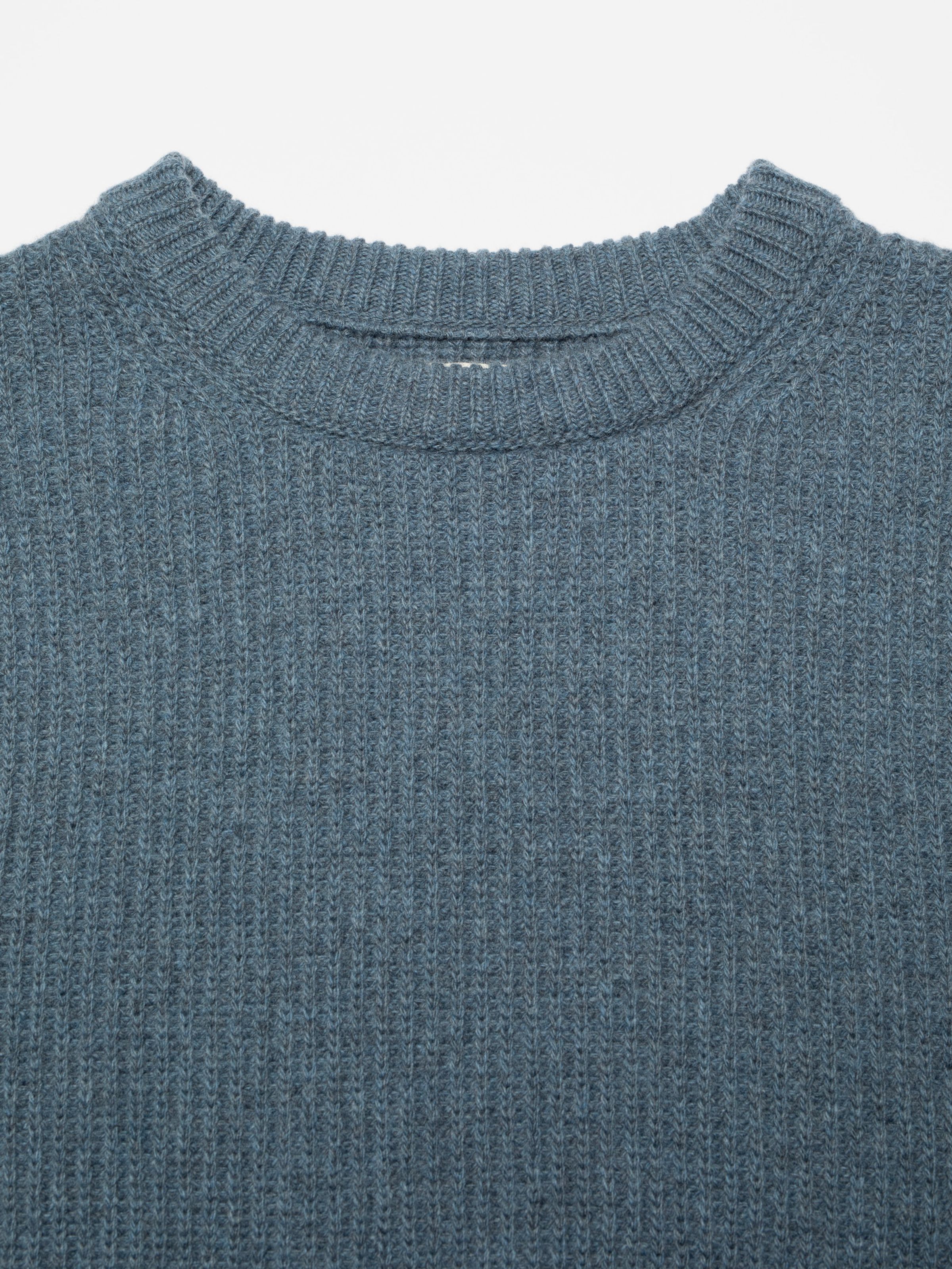 Nudie Jeans August Rib Wool Sweater in Blue Melange, a close-up of the ribbed crew neck and knit texture.