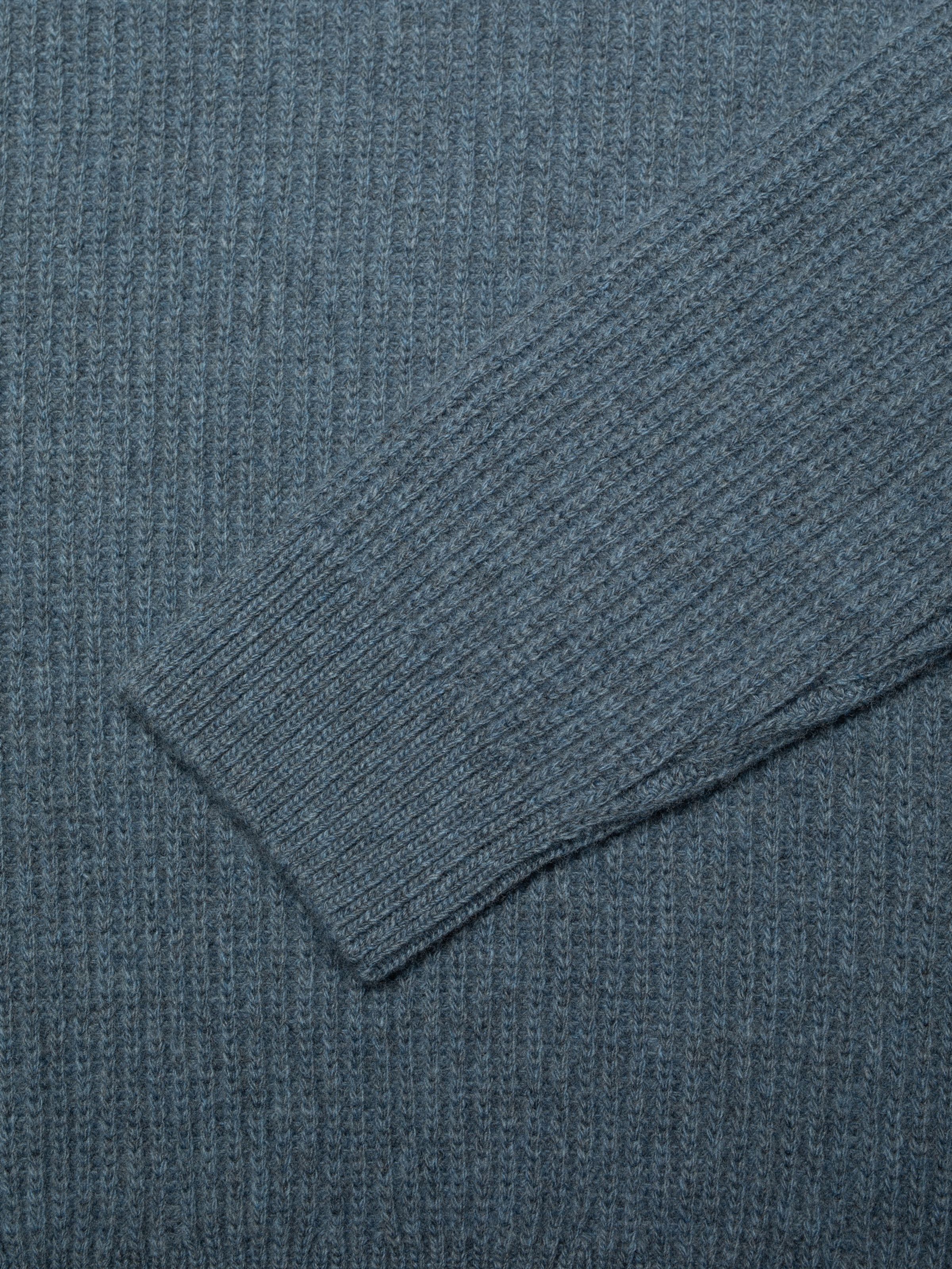 Nudie Jeans August Rib Wool Sweater in Blue Melange, a close-up showing the ribbed wool texture and sleeve detail.