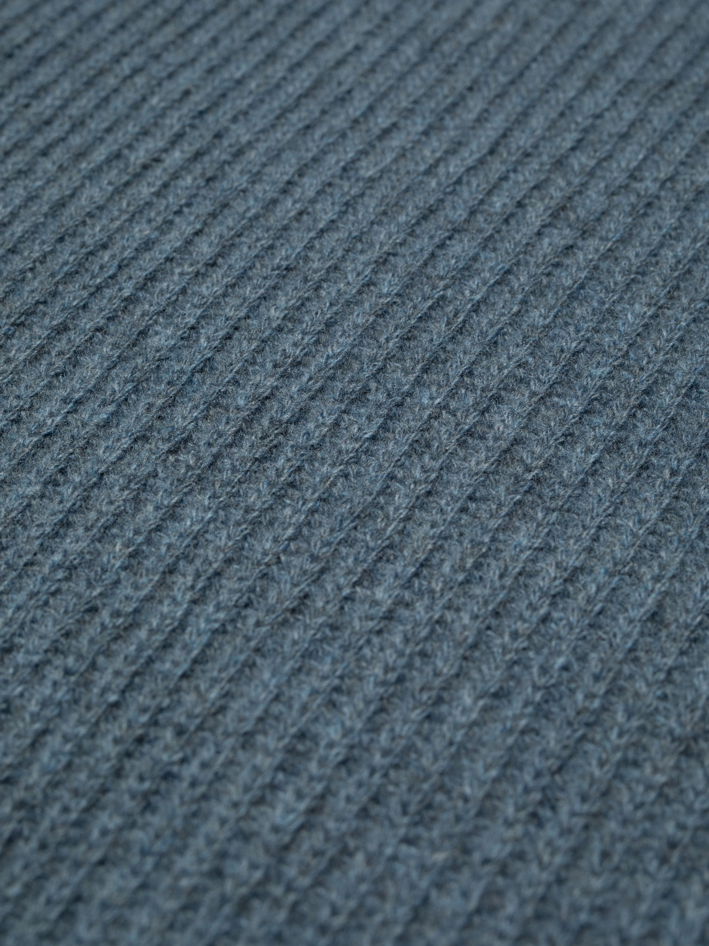 Nudie Jeans August Rib Wool Sweater in Blue Melange, a close-up of the full cardigan stitch fabric.