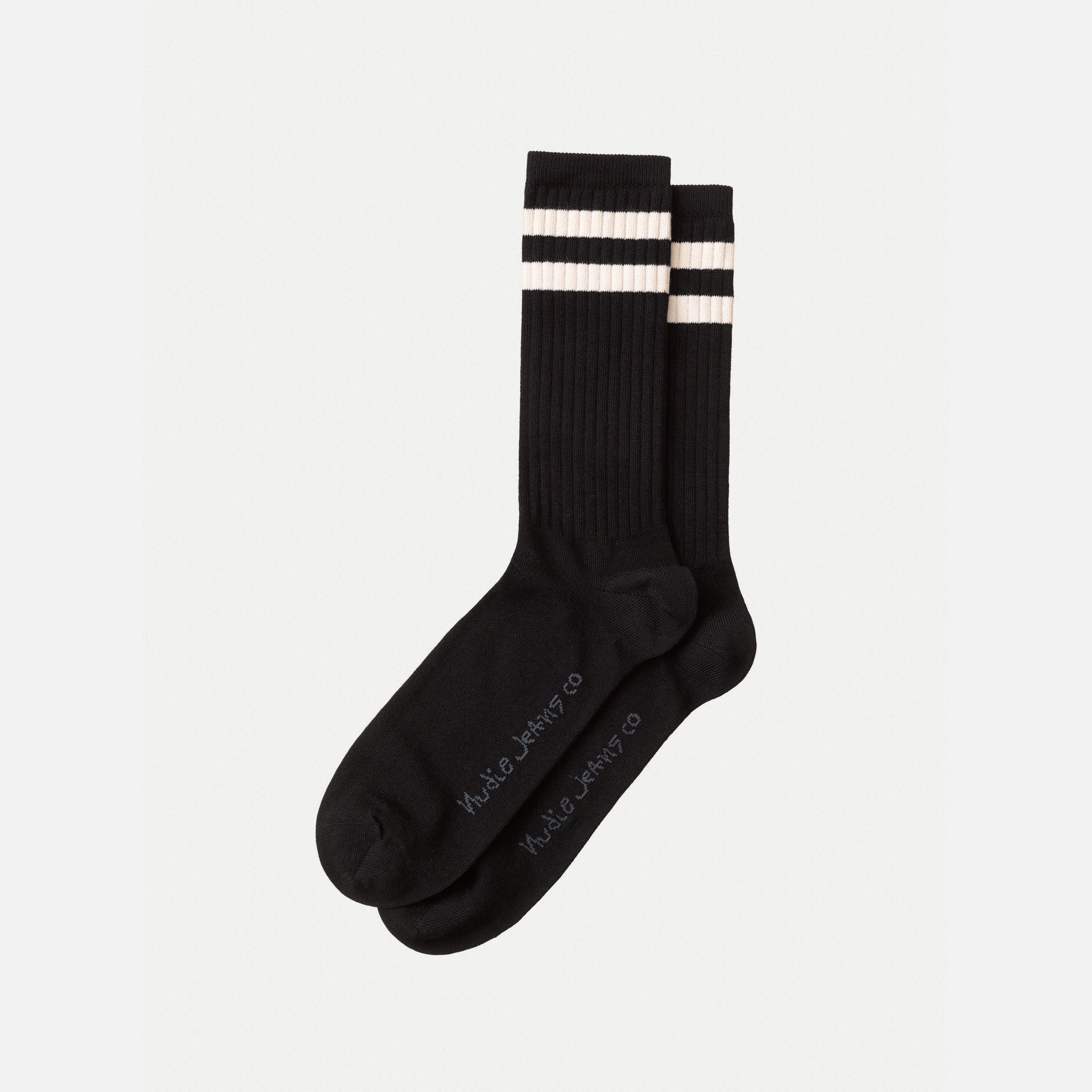 Nudie Jeans Amundsson Sport Socks in Black, a pair of black sport socks with white stripes laid flat.