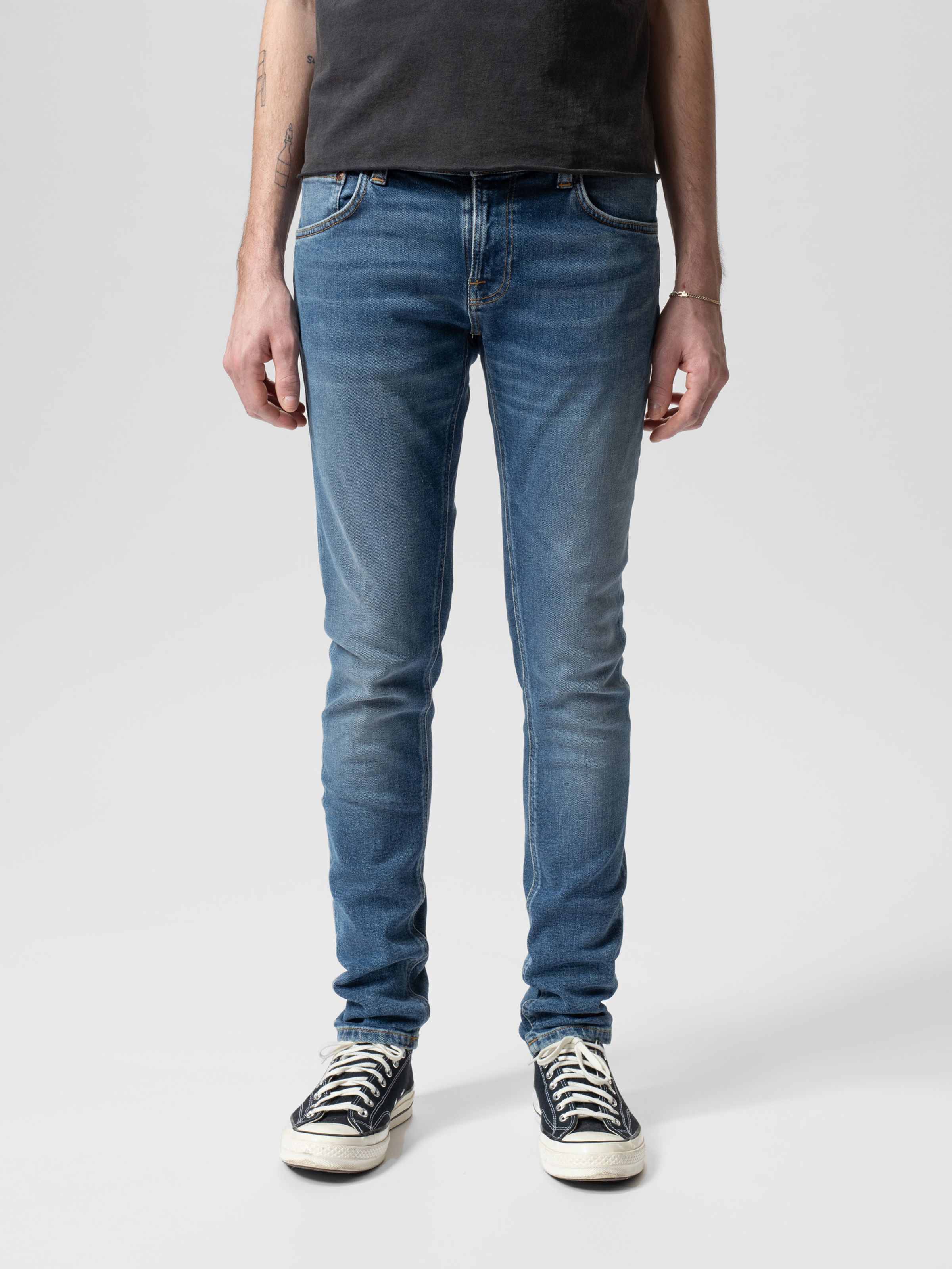 Nudie Jeans Tight Terry in Inbetween Blues, a pair of men's tight fit jeans shown from the front on a model.