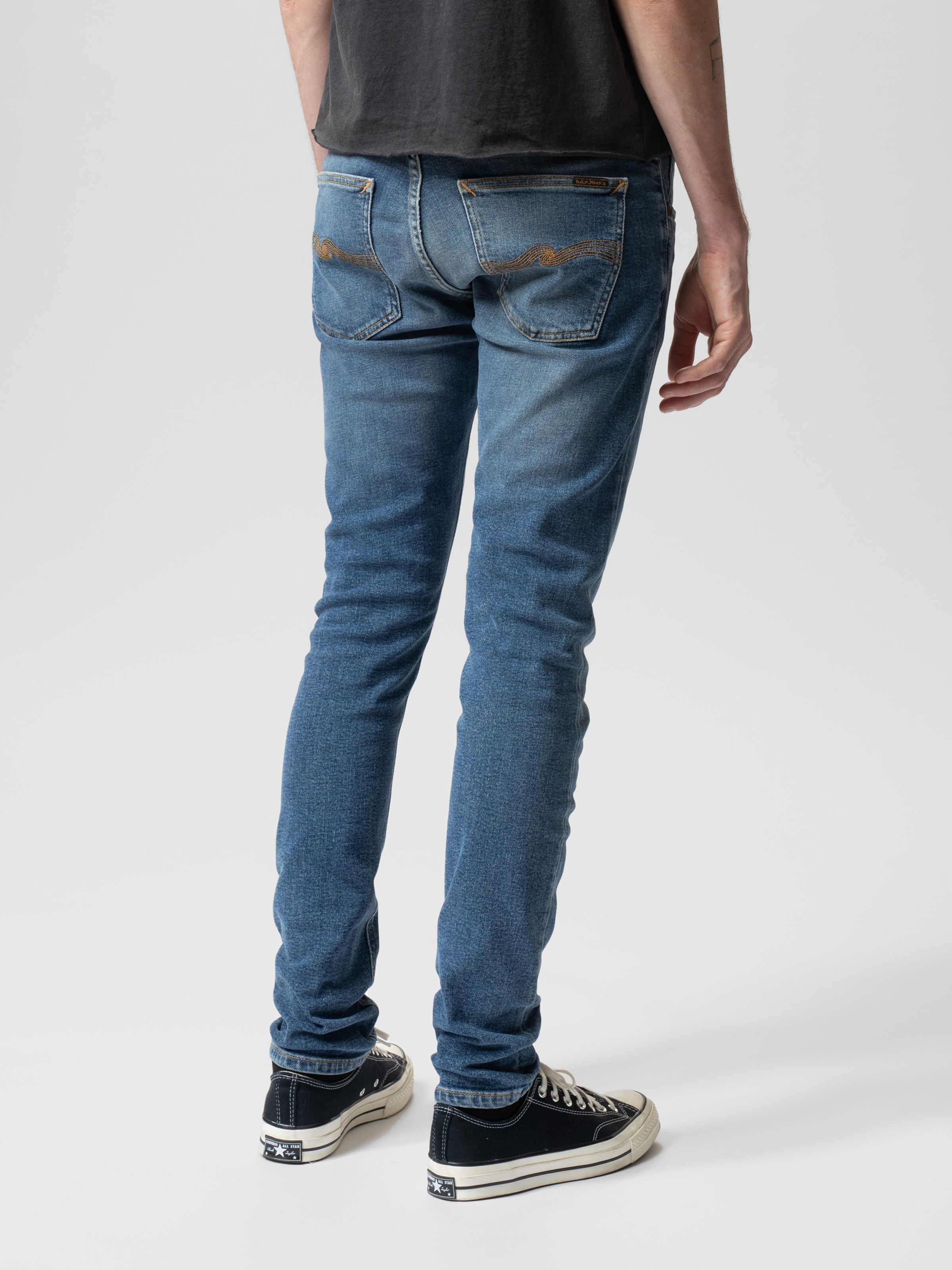 Nudie Jeans Tight Terry in Inbetween Blues, a pair of men's tight fit jeans shown on a model from the back.
