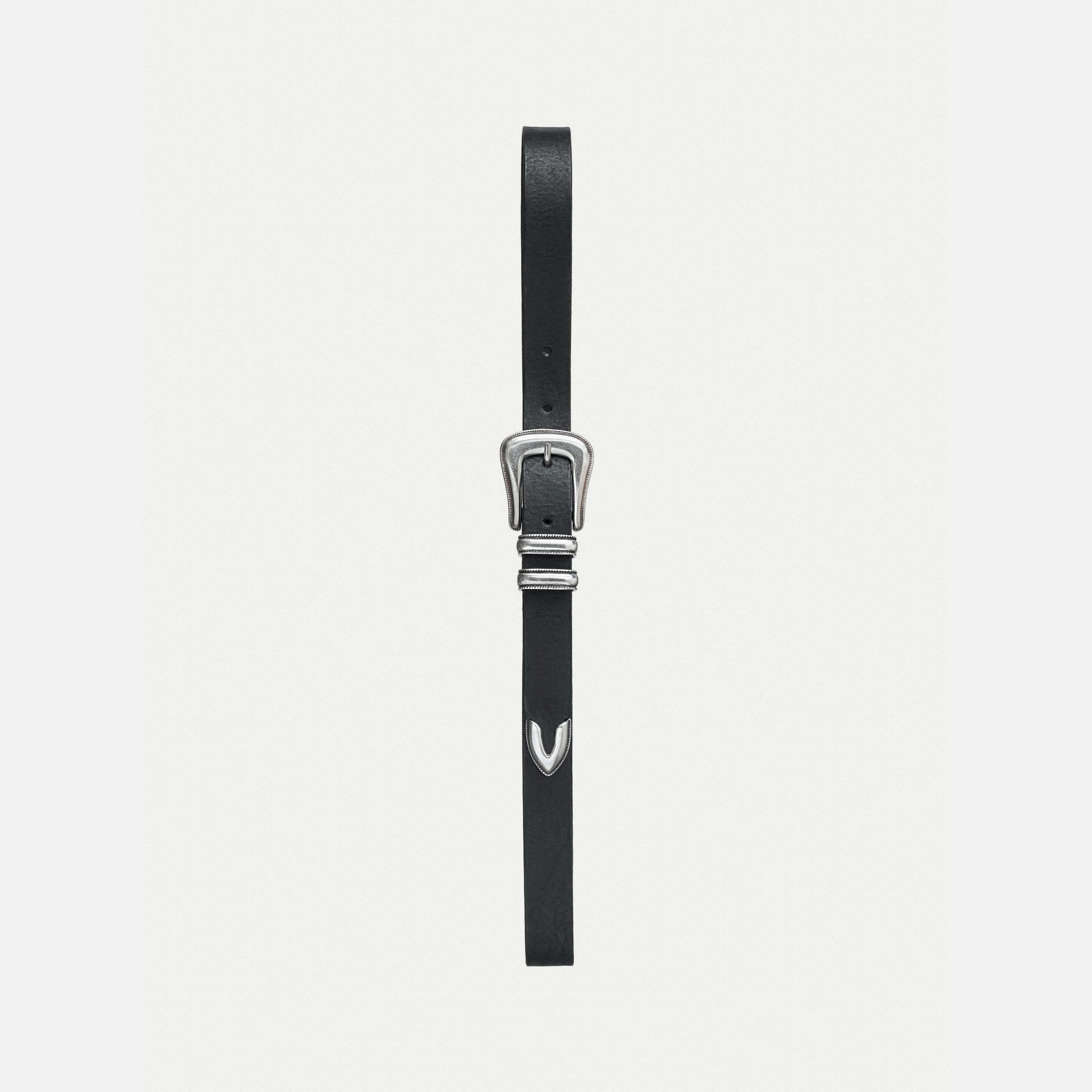 Nudie Jeans Western Silver Belt in Black, a leather belt with a silver western buckle, laid flat on a white background.