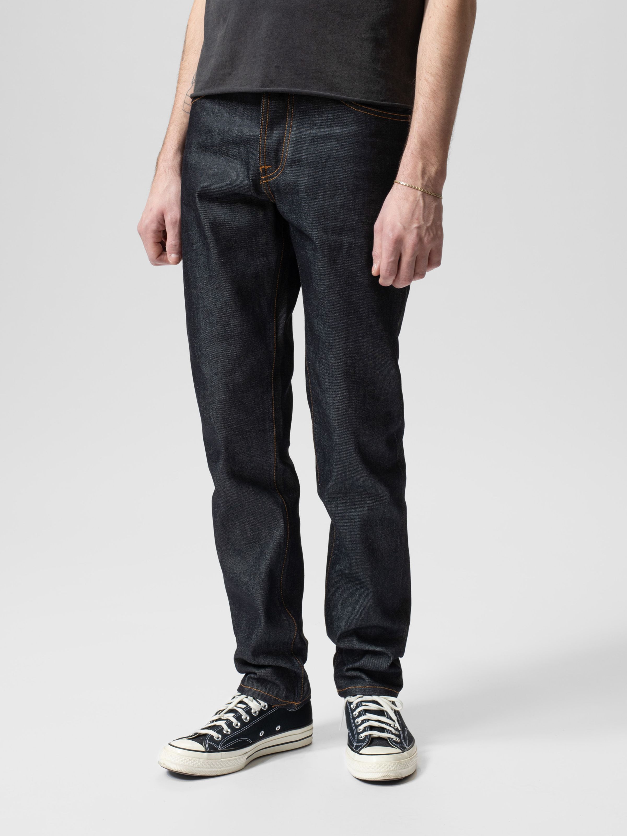 Nudie Jeans Steady Eddie II in Dry Heavy, a men's regular tapered fit jean shown on a model from the waist down.