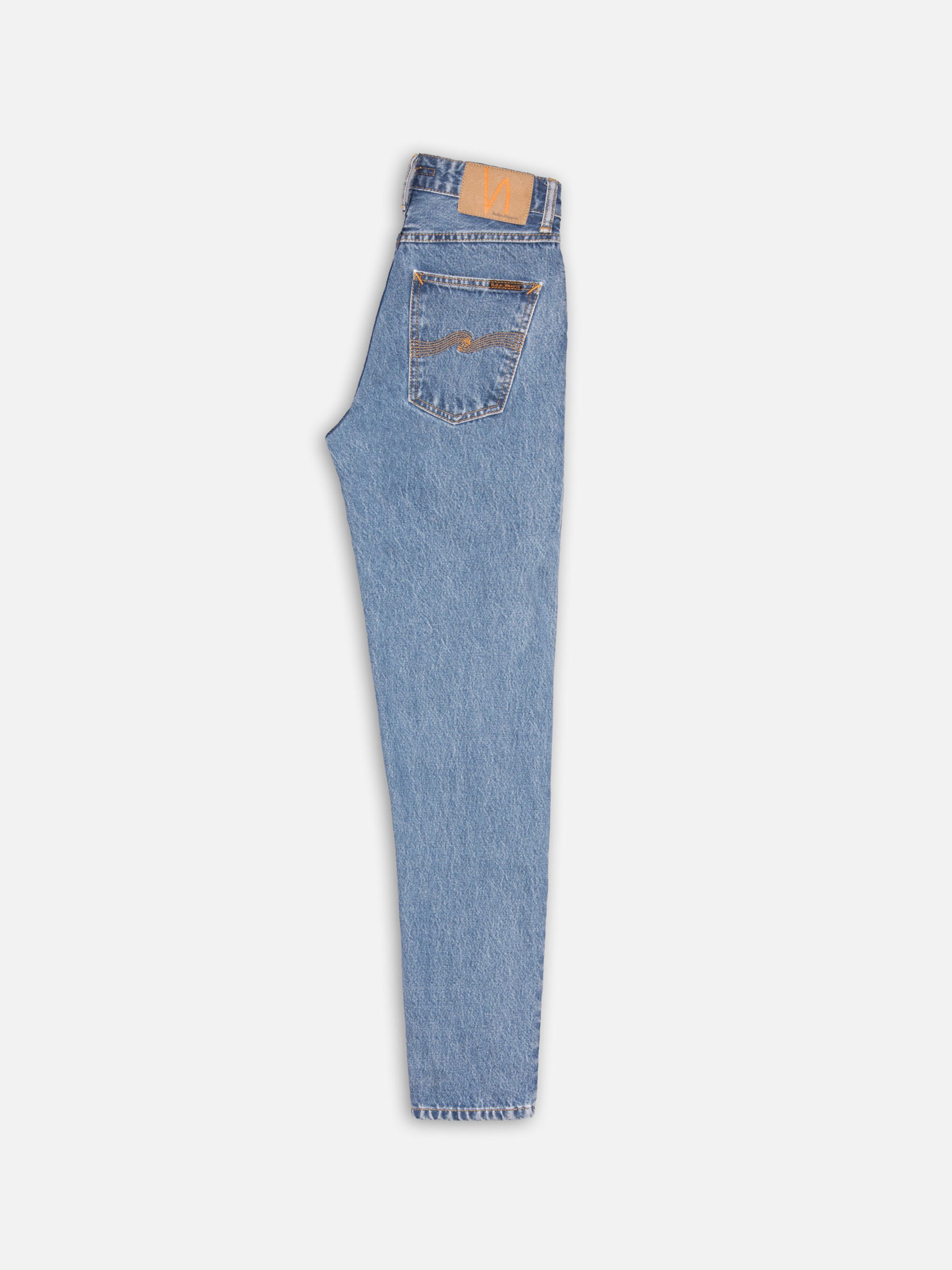 Nudie Jeans Breezy Britt Casual Blue, high-waist regular tapered jeans in mid-blue stonewash shown from the side.