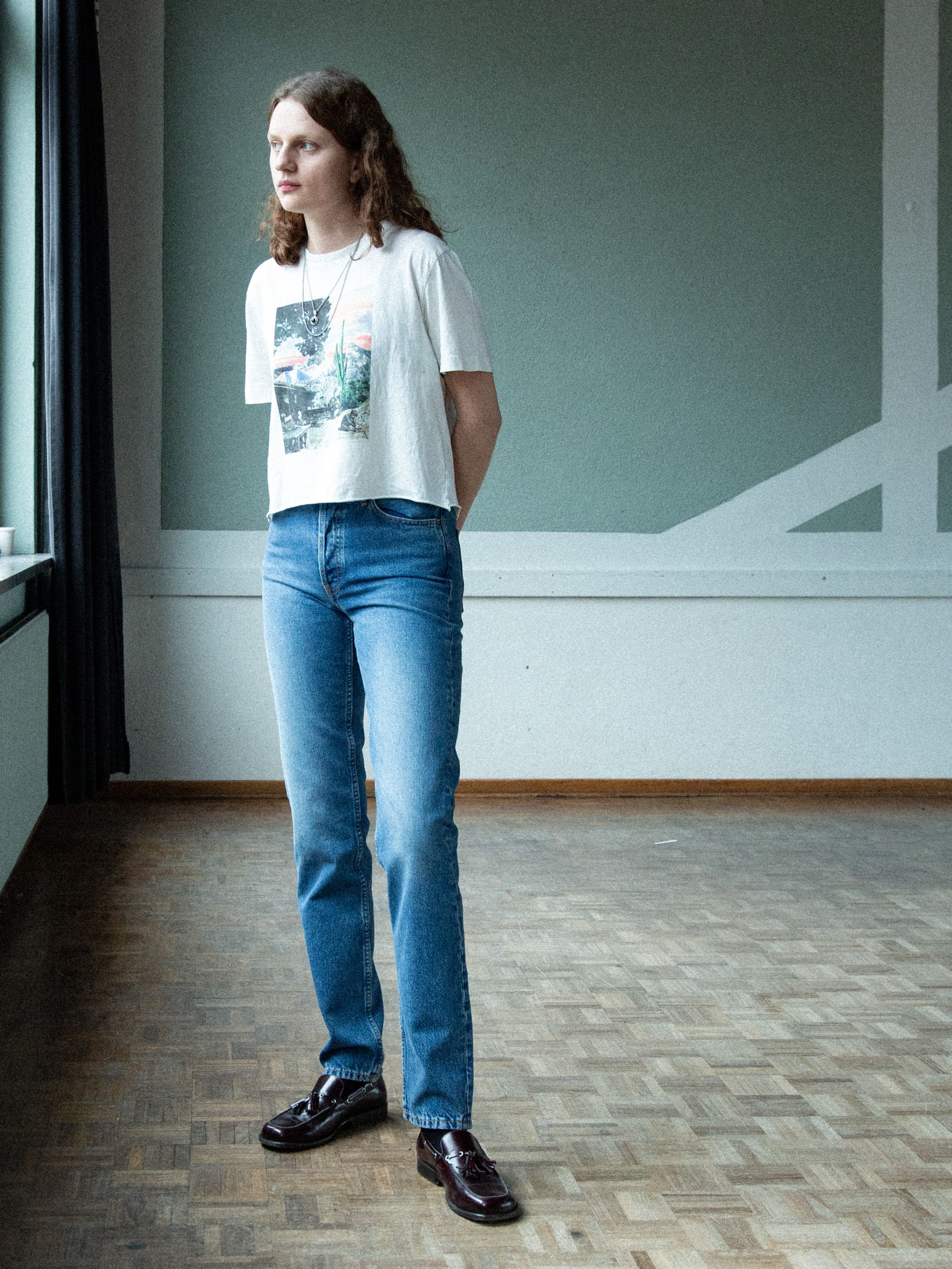 Nudie Jeans Breezy Britt Day Dreamer, women's high-waist regular fit tapered jeans in a mid-blue wash, shown on a model.