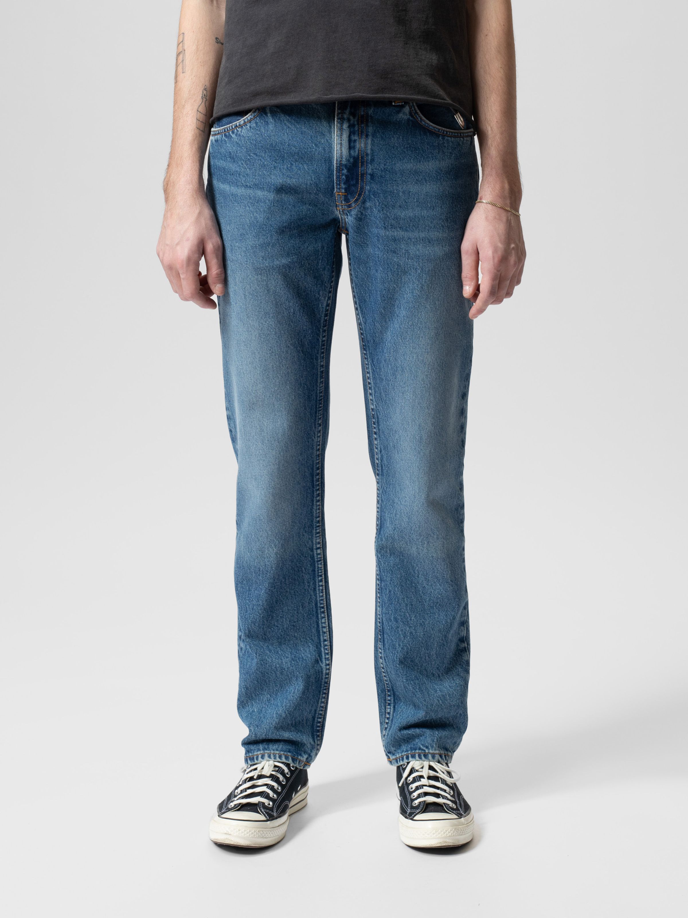 Nudie Jeans Gritty Jackson Day Dreamer, men's regular fit jeans in a mid-blue wash, shown on a model from the front.