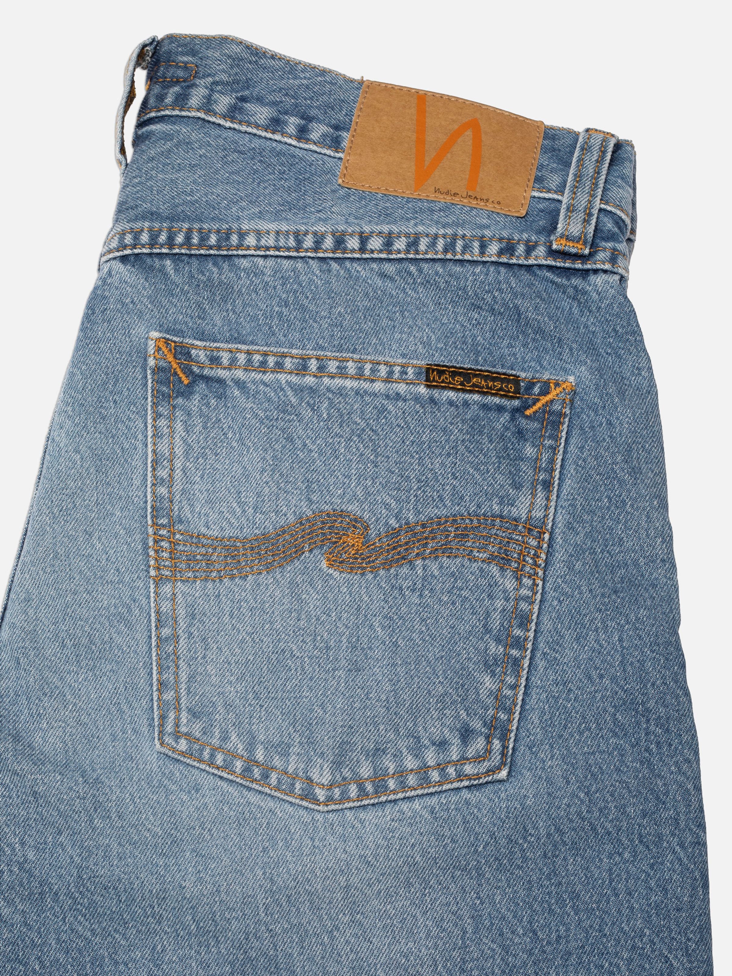 Nudie Jeans Rad Rufus Indigo Blues, straight jeans, showing a close-up of the back pocket, jacron patch, and mid-blue wash.