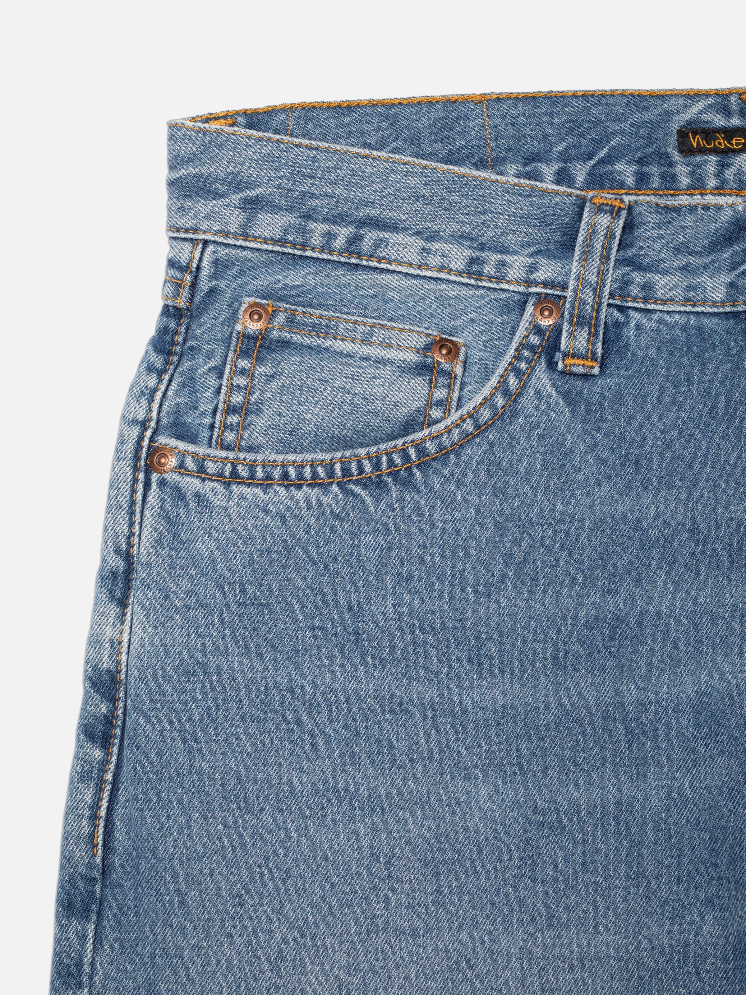 Nudie Jeans Rad Rufus Indigo Blues, regular fit jeans, showing a close-up of the front pocket and mid-blue wash texture.