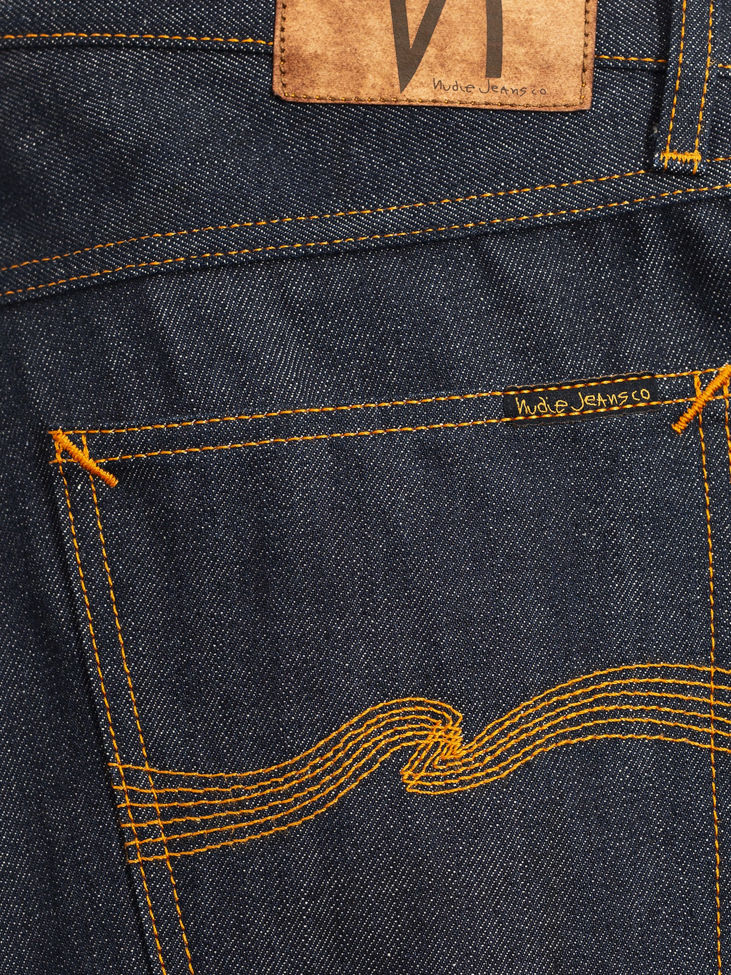 Nudie Jeans Rad Rufus Dry Selvage, men's jeans, showing a close-up of the back pocket and dry selvedge denim texture.