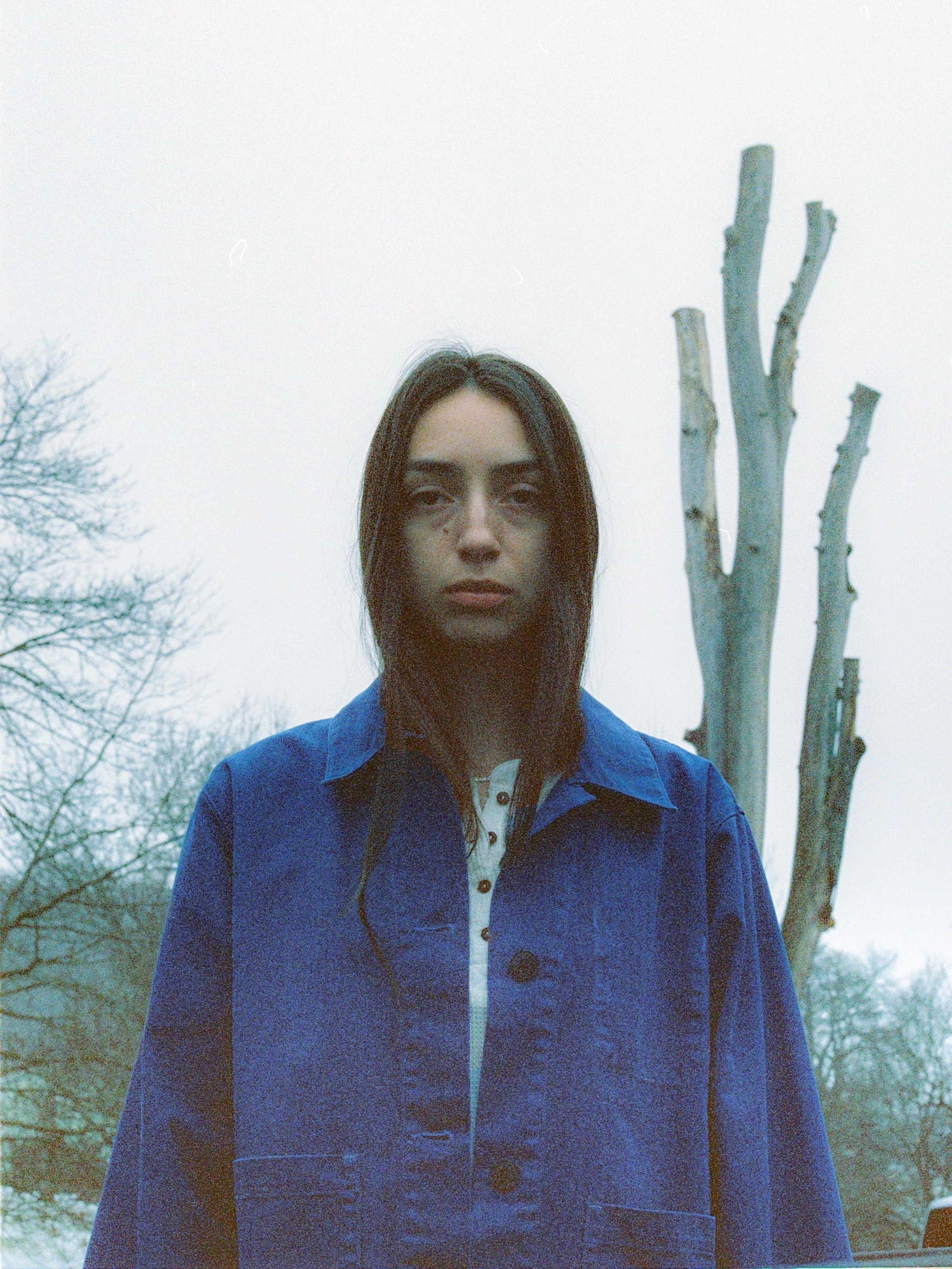 Nudie Jeans Lovis Herringbone Jacket Blue, a women's regular-fit work jacket shown from the front on a model outdoors.