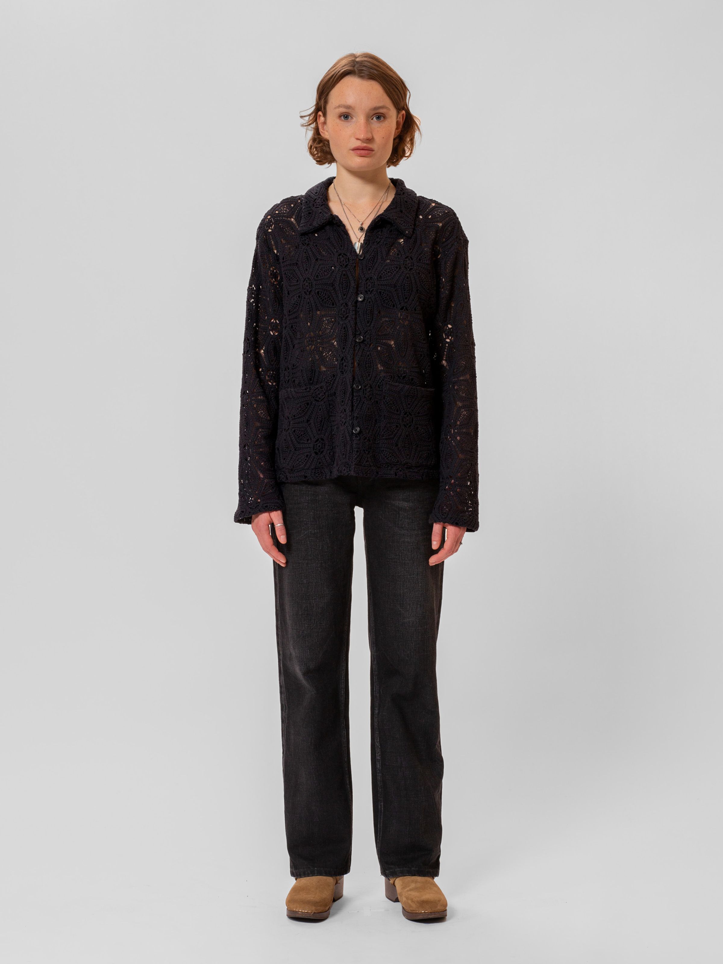 Nudie Jeans Anita Crochet Cardigan in Black, a women's macramé lace cardigan worn by a model and shown from the front.