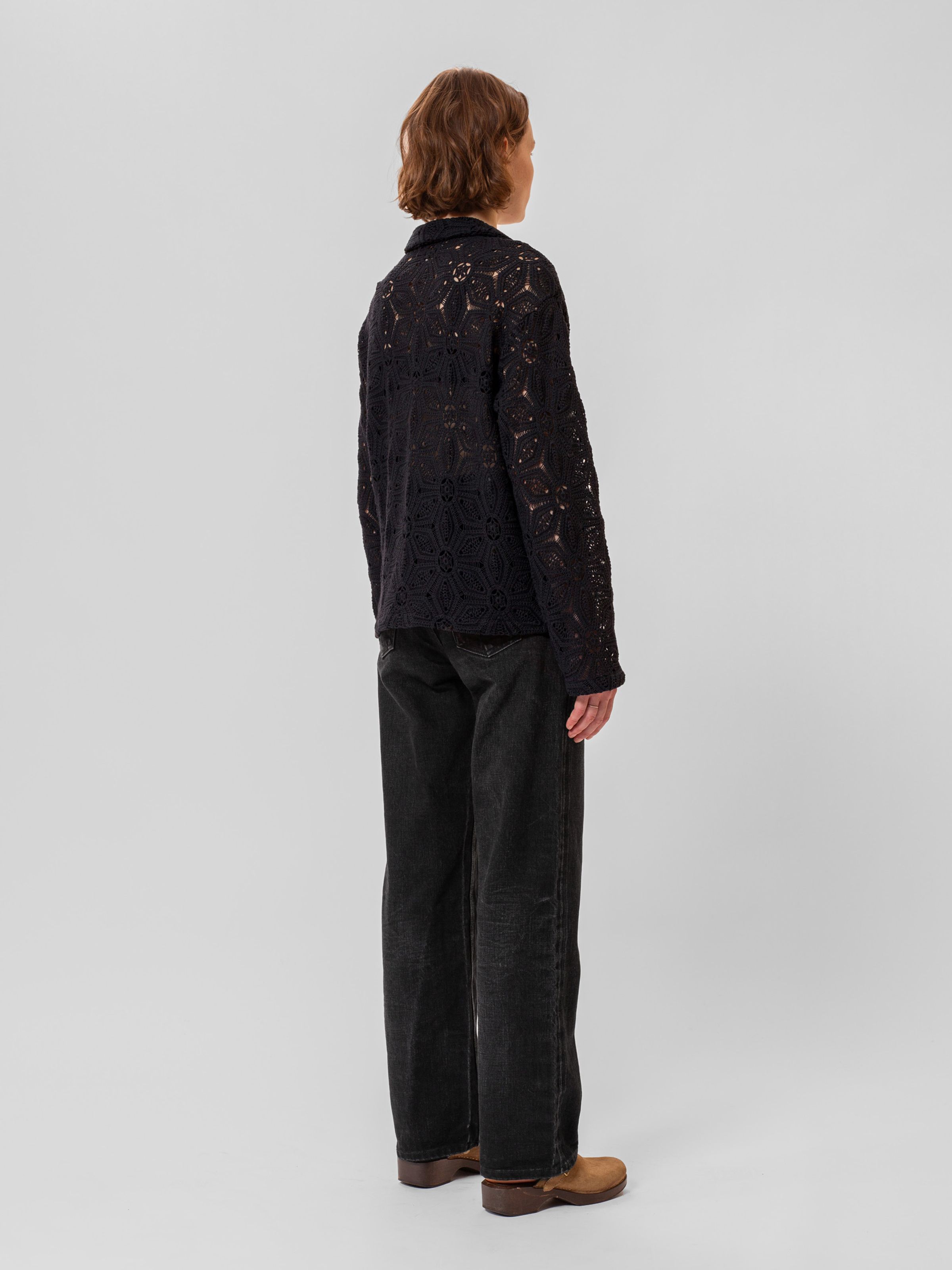 Nudie Jeans Anita Crochet Cardigan in Black, a women's regular fit cardigan, worn by a model viewed from the back and side.