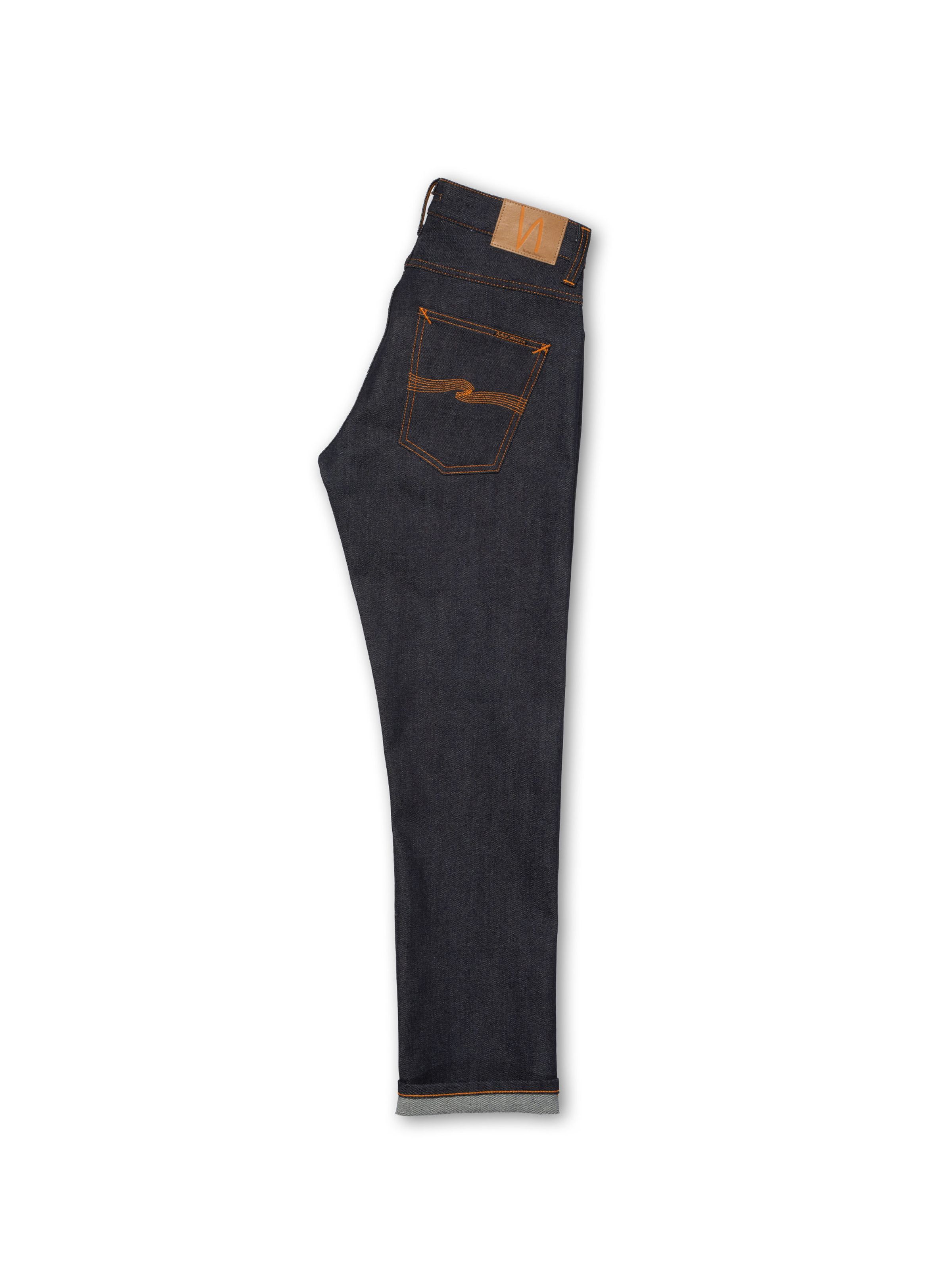 Nudie Jeans Grim Tim Dry Japan Selvage, men's slim fit jeans, shown folded and laid flat on a white background.