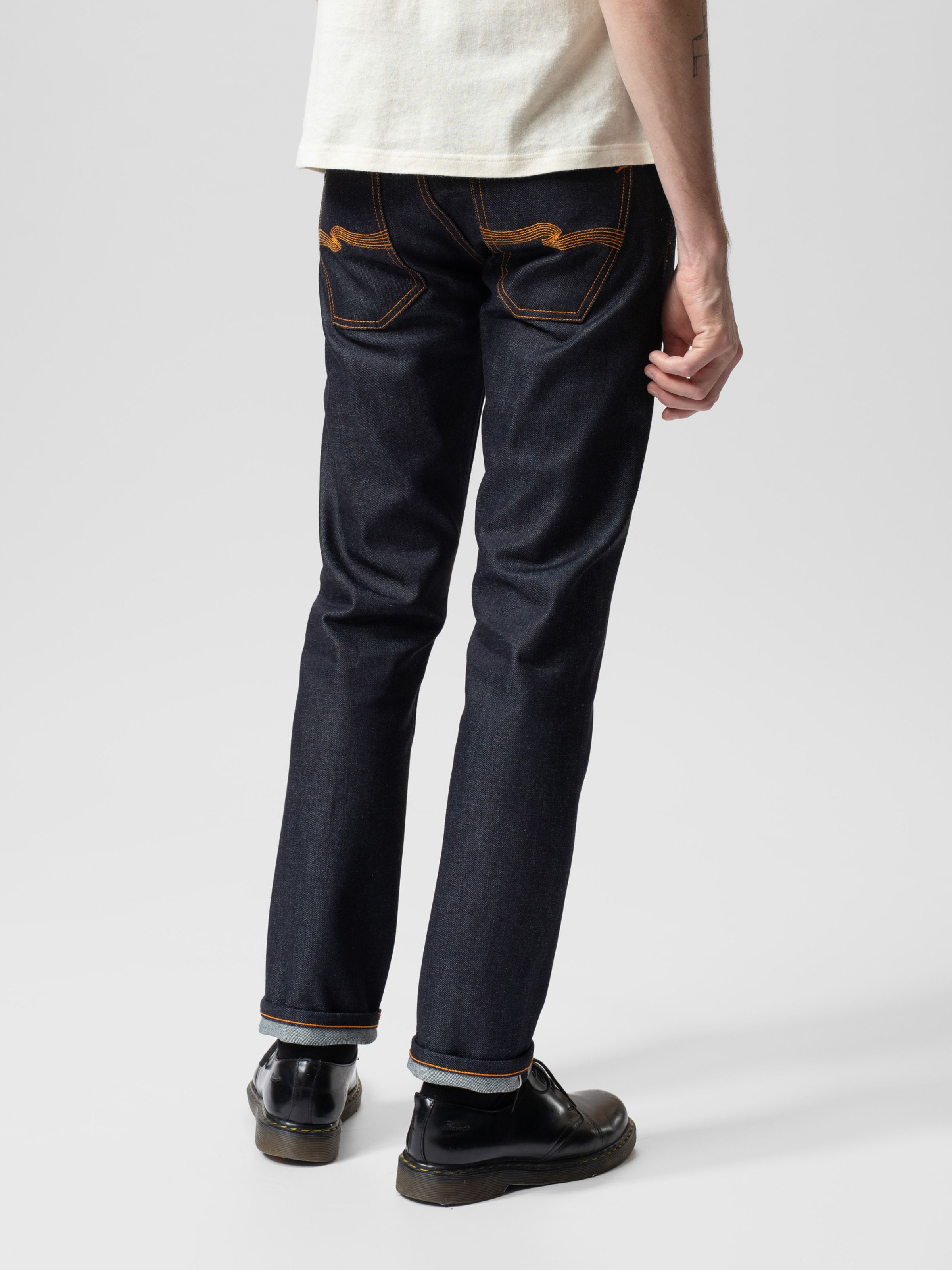 Nudie Jeans Grim Tim Dry Japan Selvage, a men's slim fit jean shown on a model from the back.