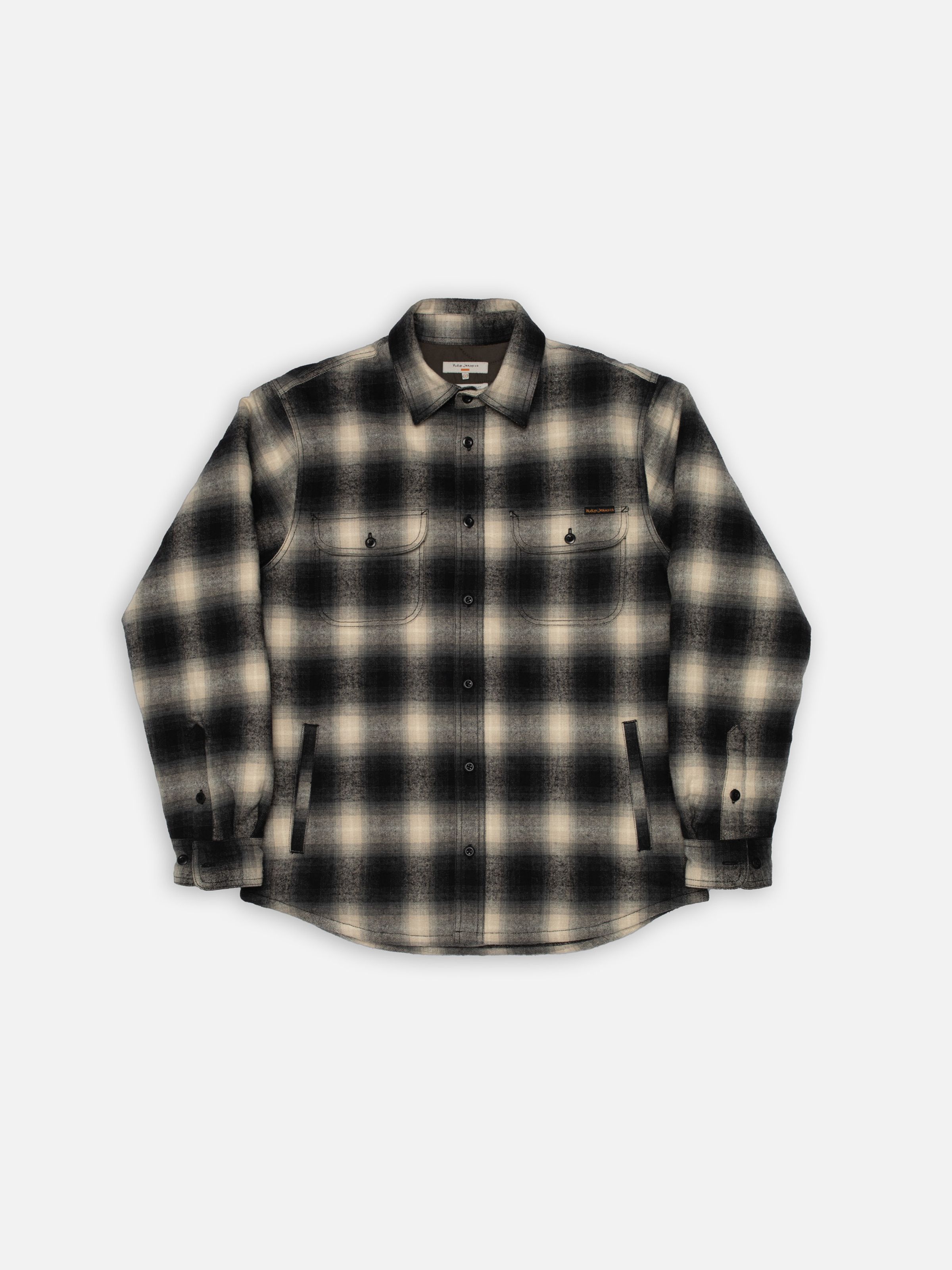 Nudie Jeans Glenn Padded Shadow Check Shirt Black, a men's padded overshirt in a shadow check pattern, shown laid flat.