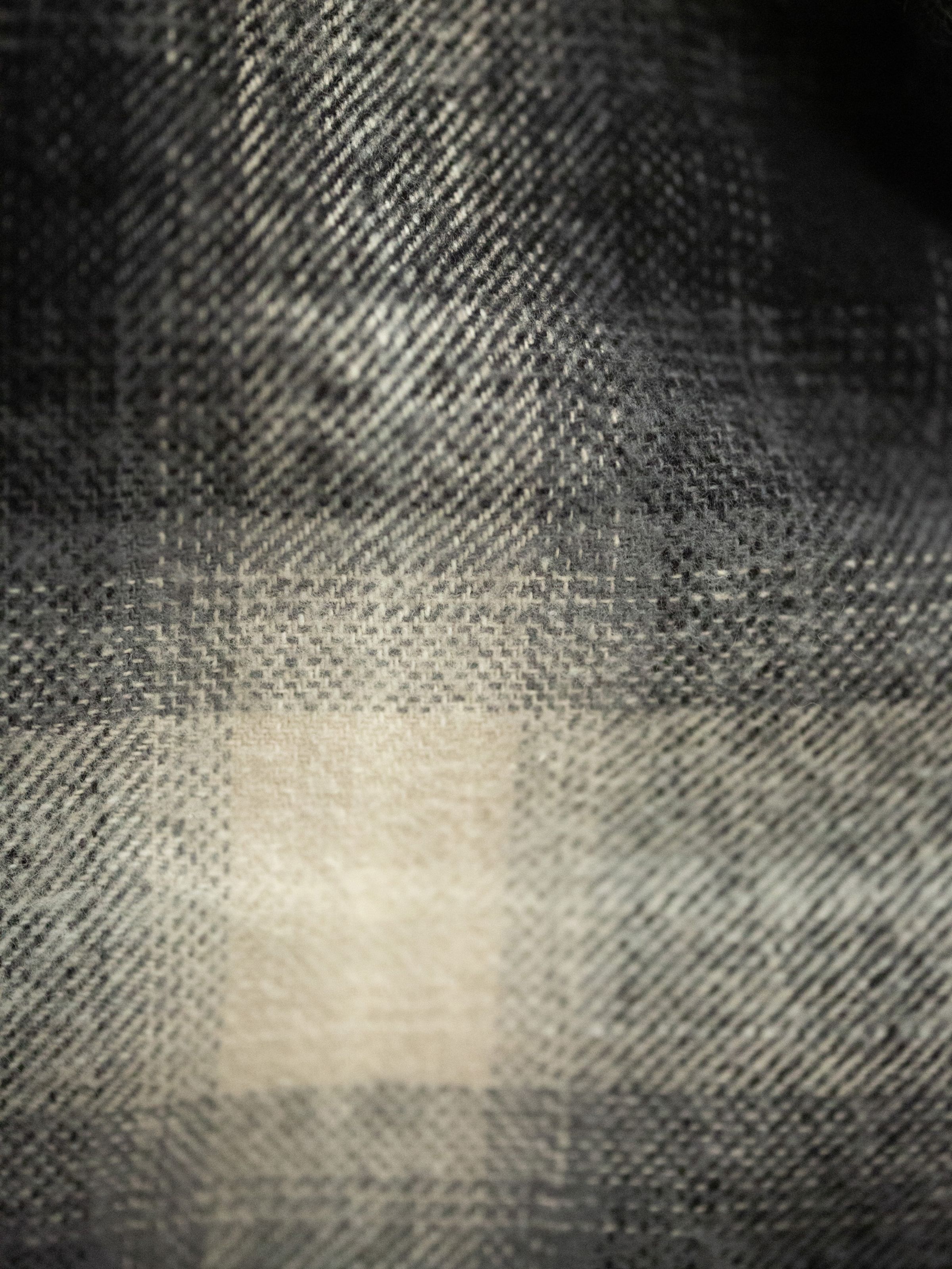 Nudie Jeans Glenn Padded Shadow Check Shirt in Black, a men's overshirt shown in a close-up of the flannel fabric.