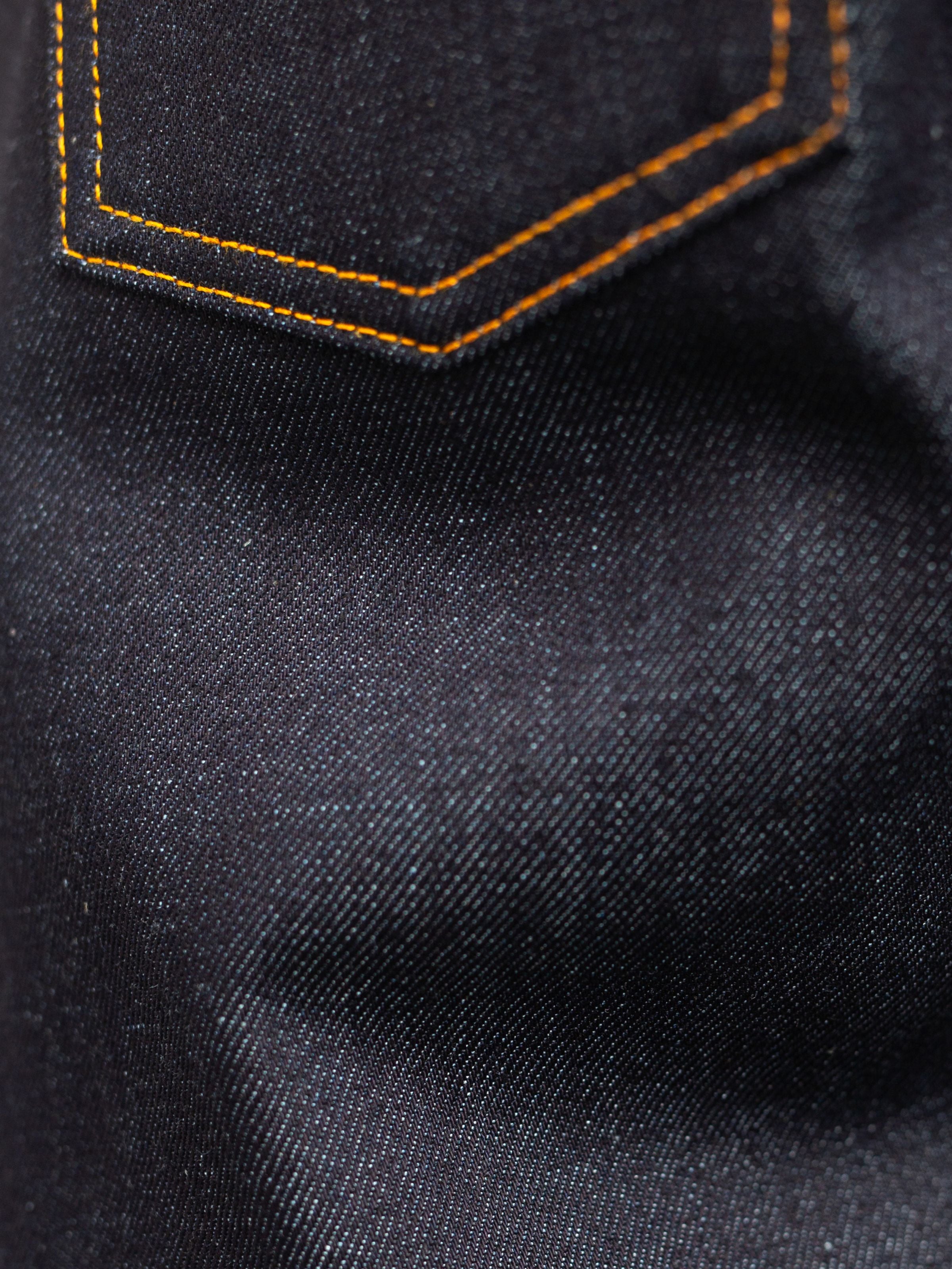 Nudie Jeans Solid Ollie Dry Japan Selvage, close-up of pocket and selvedge denim texture.