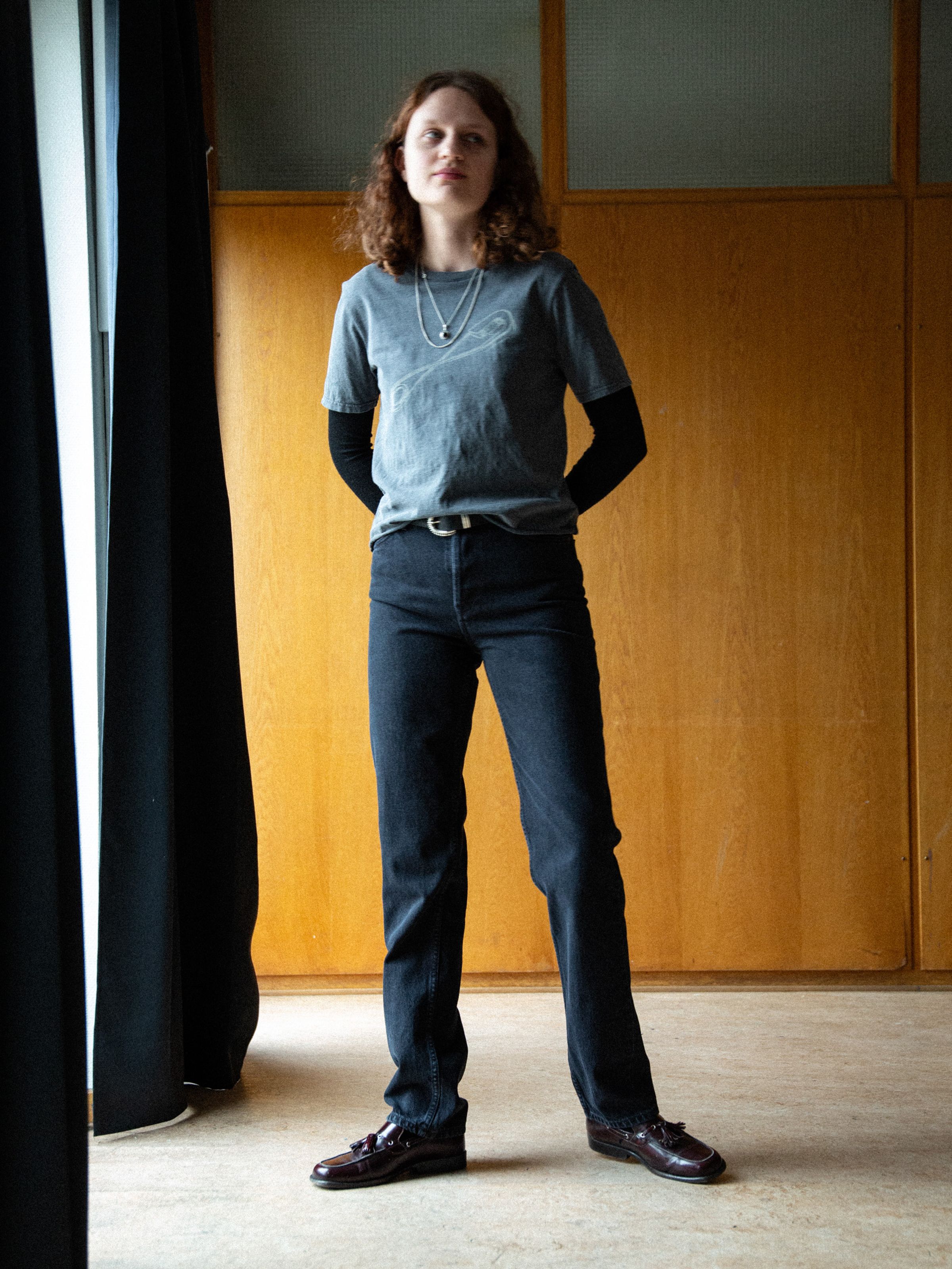 Nudie Jeans Lofty Lo Black Vintage, women's high waist straight leg jeans in washed black organic denim on a model.