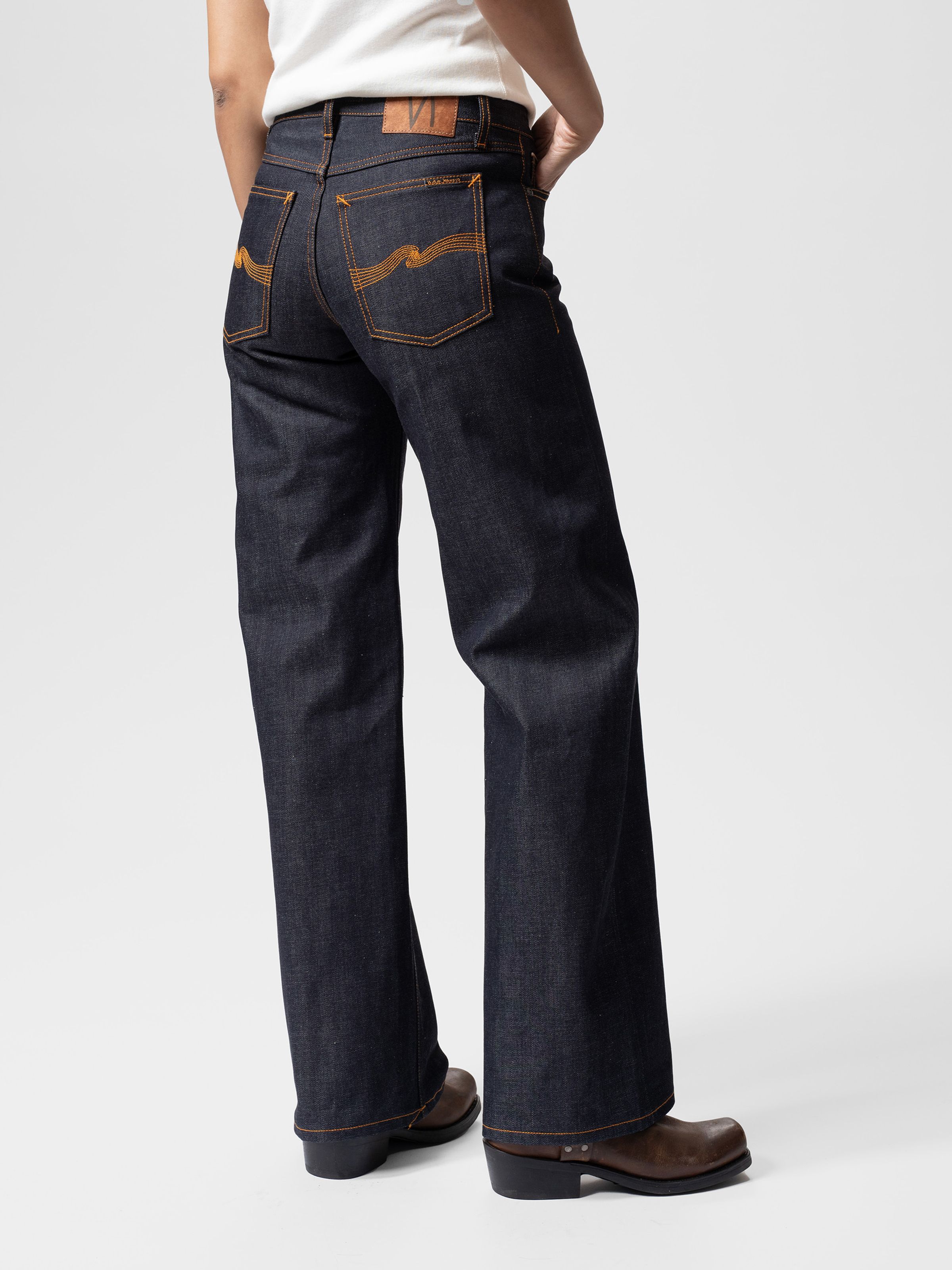 Nudie Jeans Wide Heidi Dry Selvage, women's loose wide-leg jeans in dry blue shown from the back on a model.