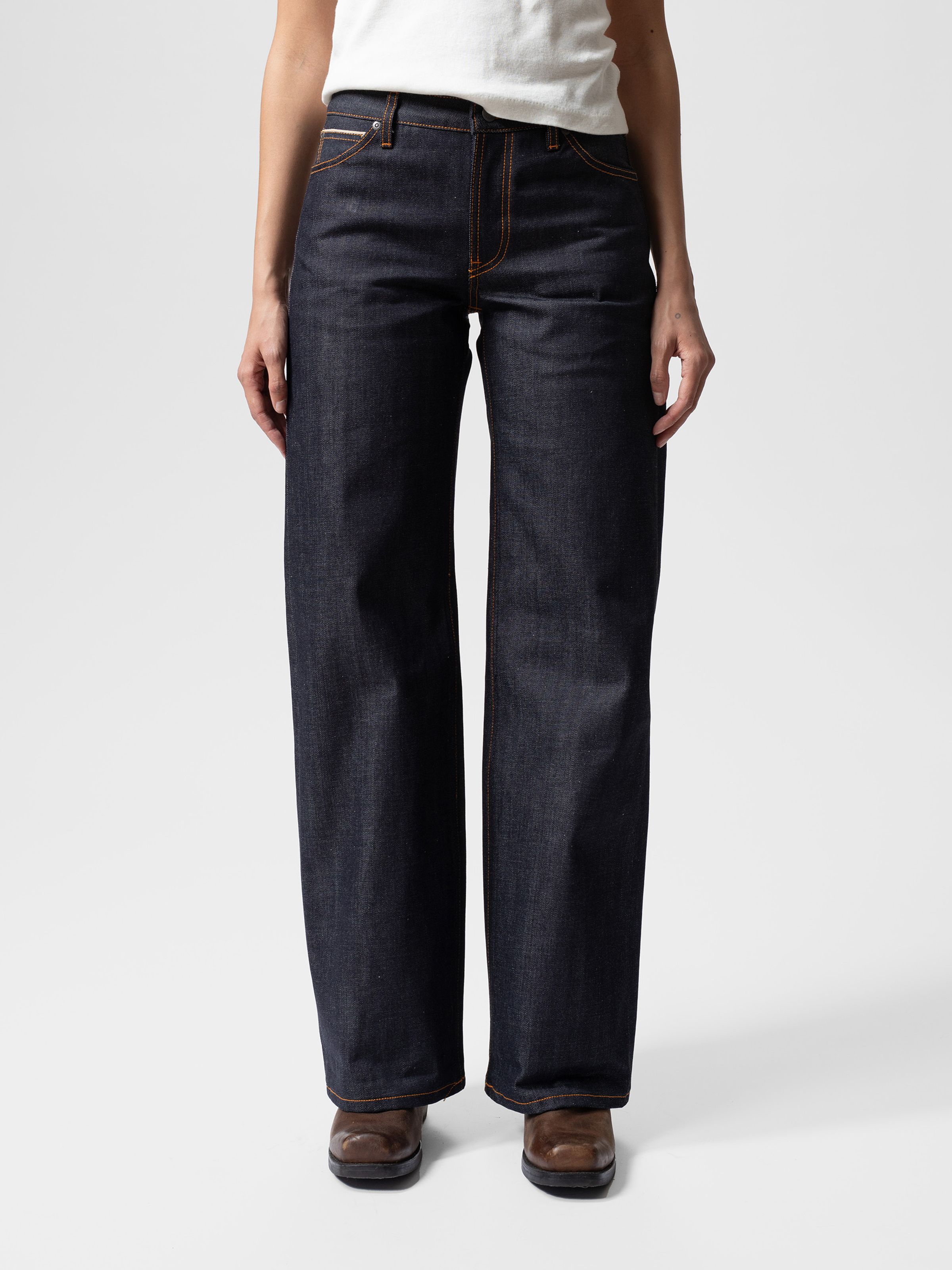Nudie Jeans Wide Heidi Dry Selvage, women's loose wide-leg jeans in dark blue selvedge denim shown from the waist down.