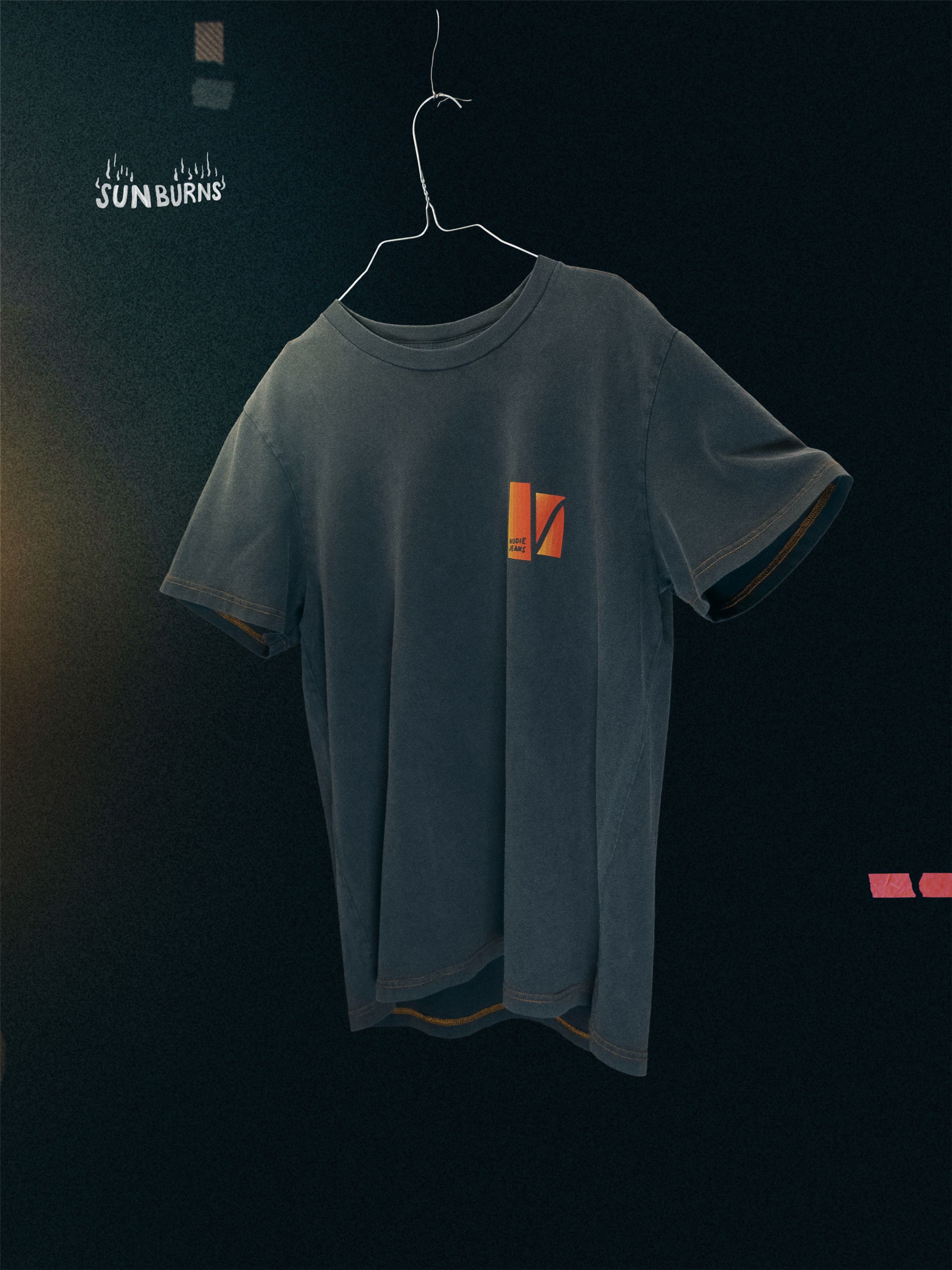 Nudie Jeans Roy Sunburns T-Shirt in Antracite, a men's regular fit t-shirt, shown hanging on a wire hanger.