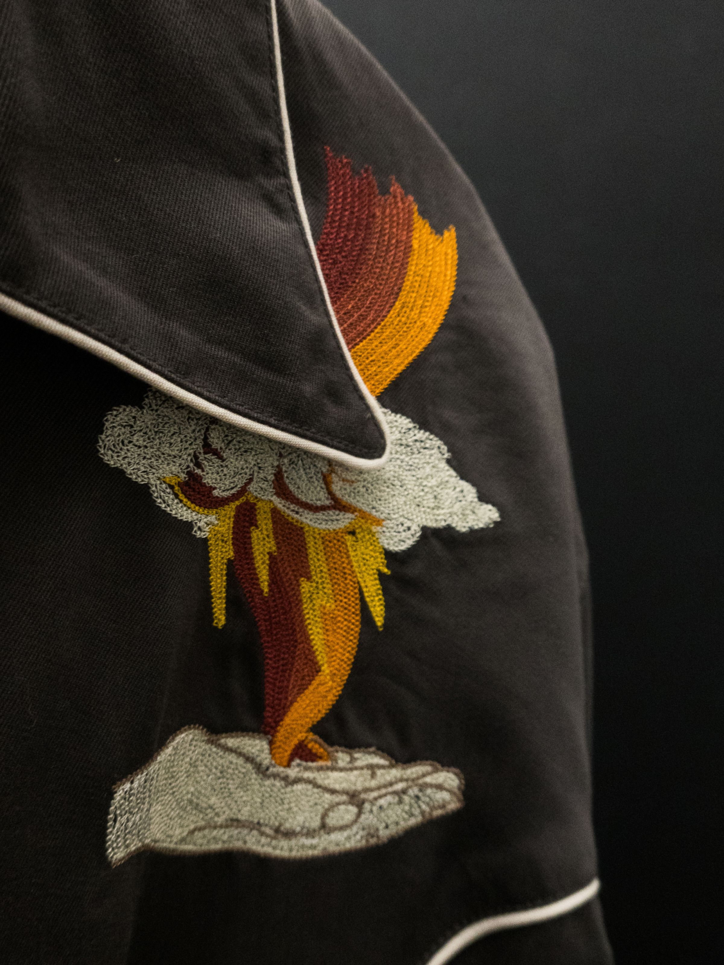 Nudie Jeans Gonzo Western Shirt Sunburns in black/brown, a close-up of the vintage-style embroidery on the chest.