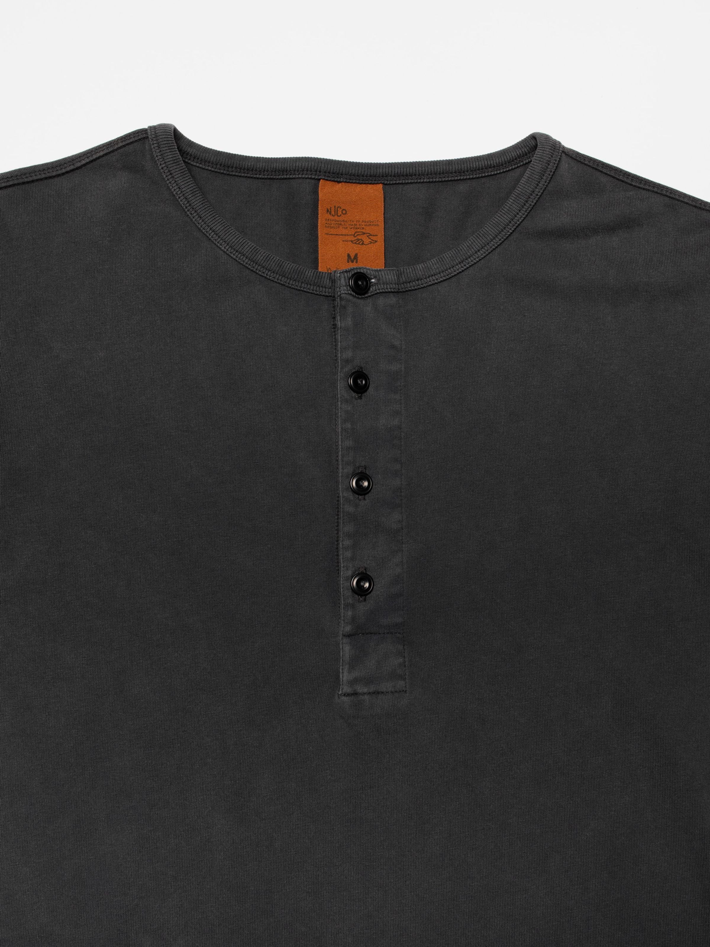 Nudie Jeans LS Henley Washed in Antracite, close-up of the four-button placket and neckline on organic cotton jersey.