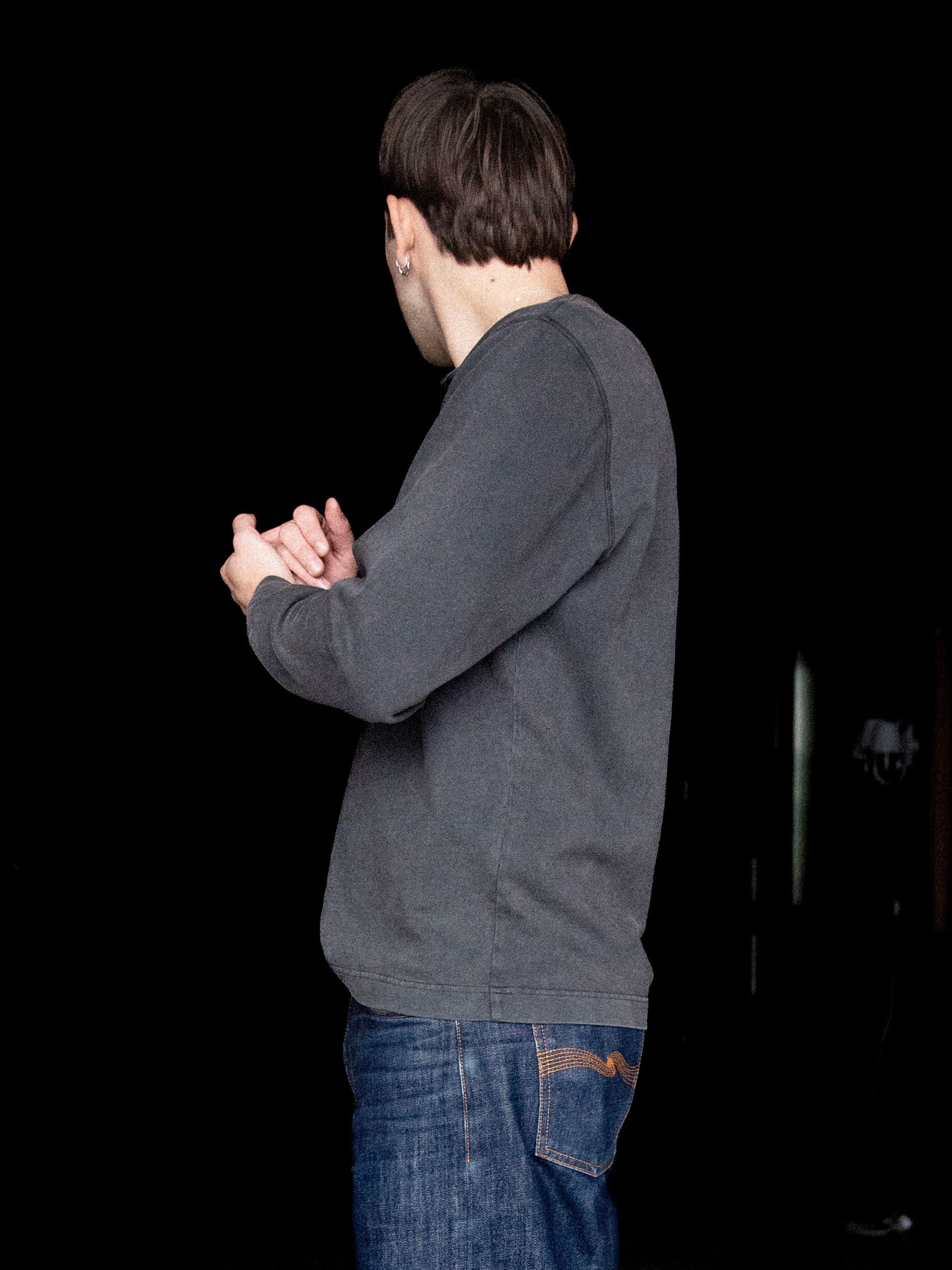 Nudie Jeans Long Sleeve Henley Washed Antracite, a men's regular fit organic cotton shirt shown from the side on a model.