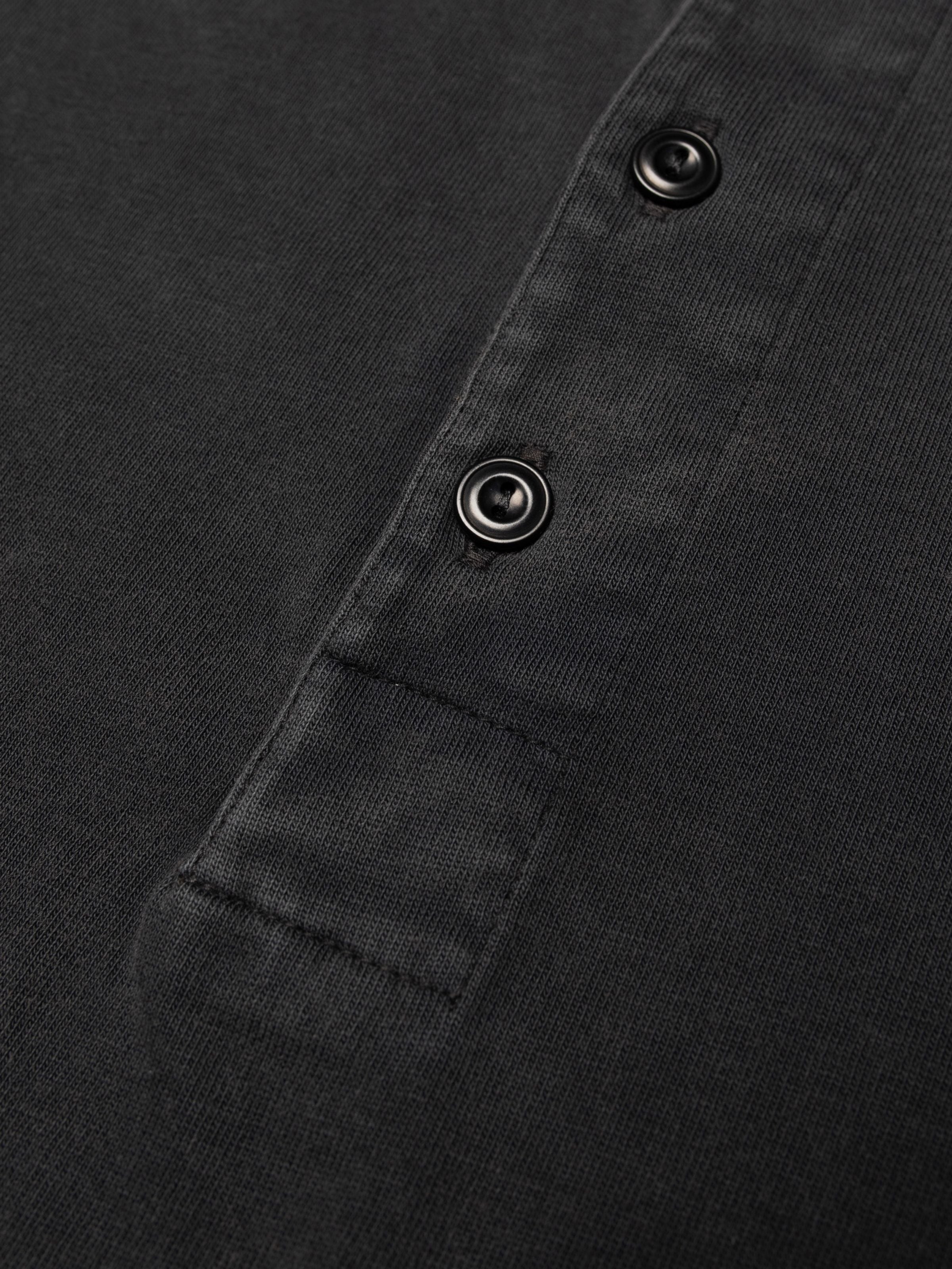 Nudie Jeans LS Henley Washed in Antracite, close-up of the four-button placket and organic cotton jersey fabric.