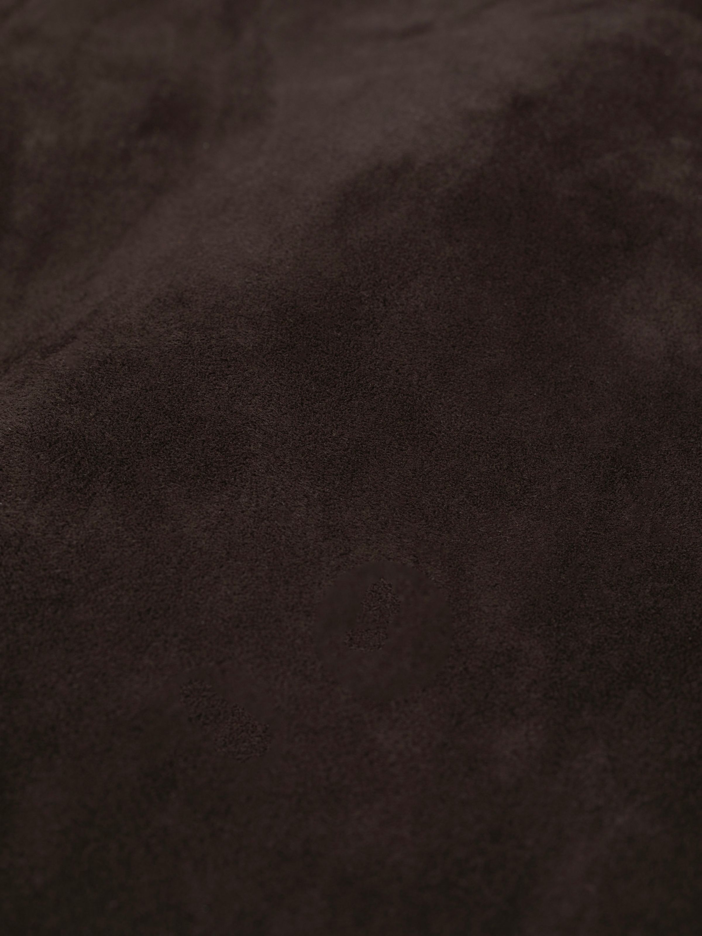 Nudie Jeans Dante II Suede Jacket in Dark Brown, a close-up showing the texture of the soft goat suede fabric.