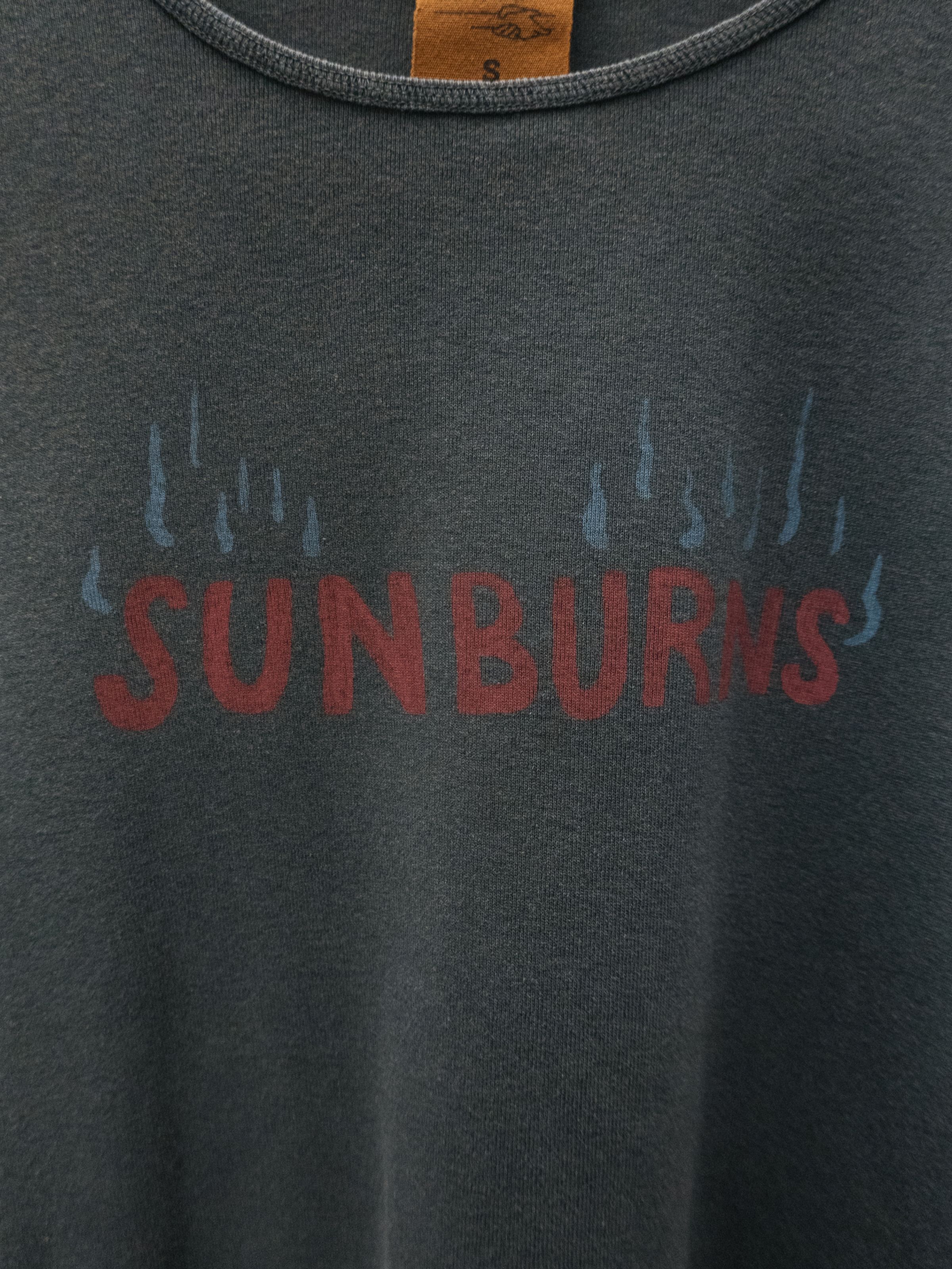 Nudie Jeans Eve Sunburns T-Shirt, a women's slim fit t-shirt in black, shown in a detailed close-up of the chest print.