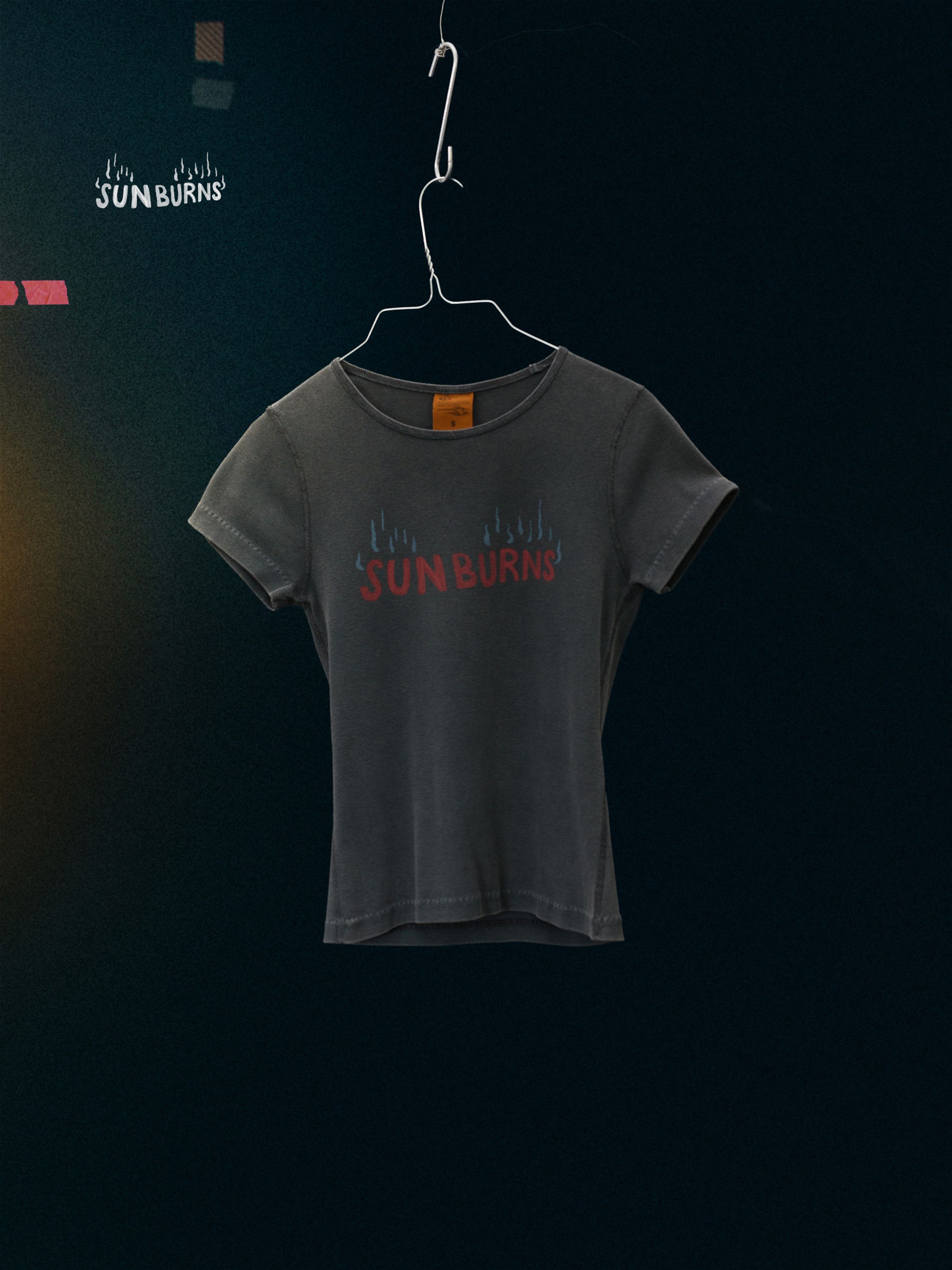 Nudie Jeans Eve Sunburns T-Shirt, a women's slim fit t-shirt in faded black with a chest print, shown laid flat.