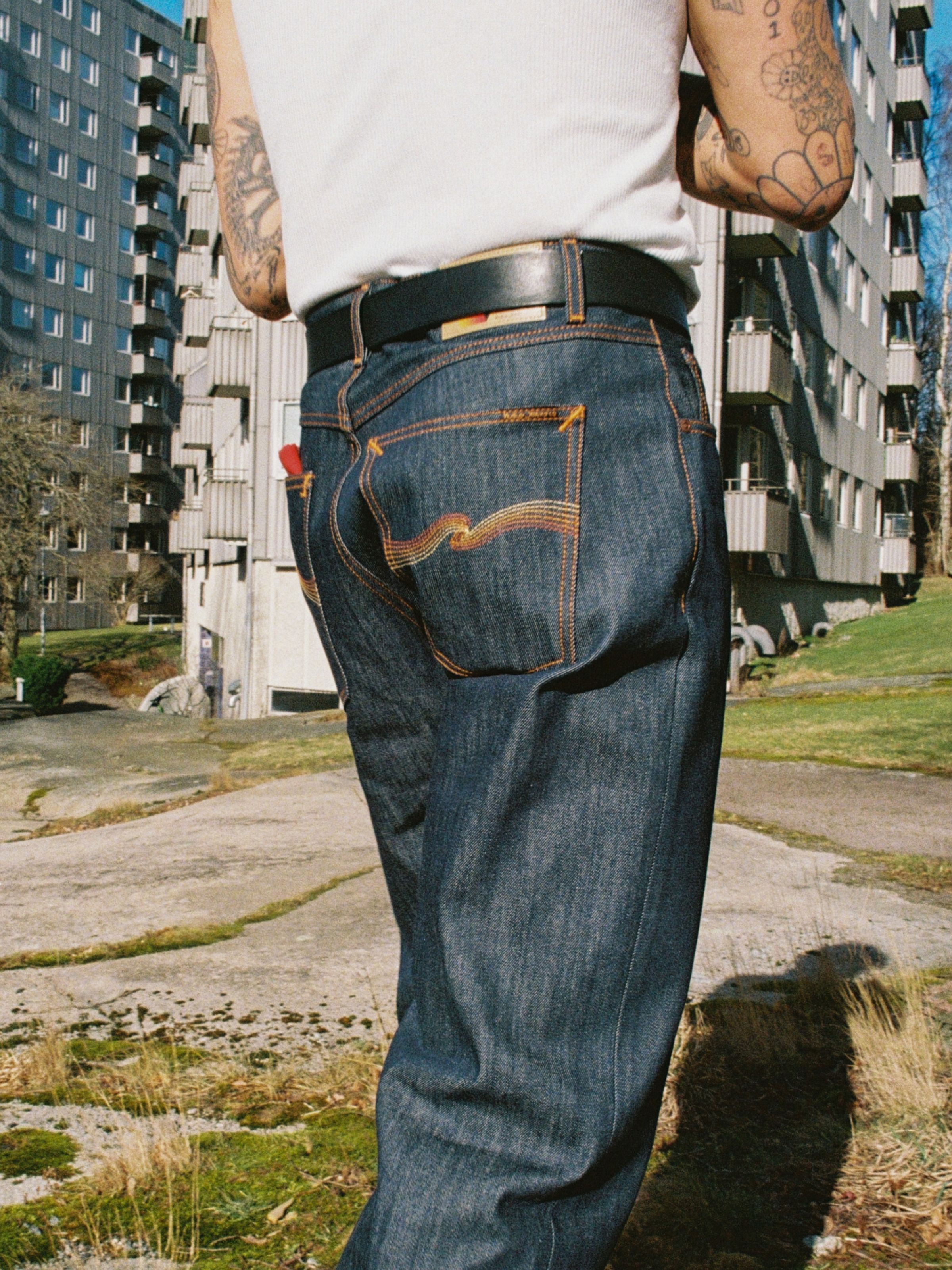 Nudie Jeans Tuff Tony Dry Sunburns, a men's loose fit jean worn by a model and shown from the back.