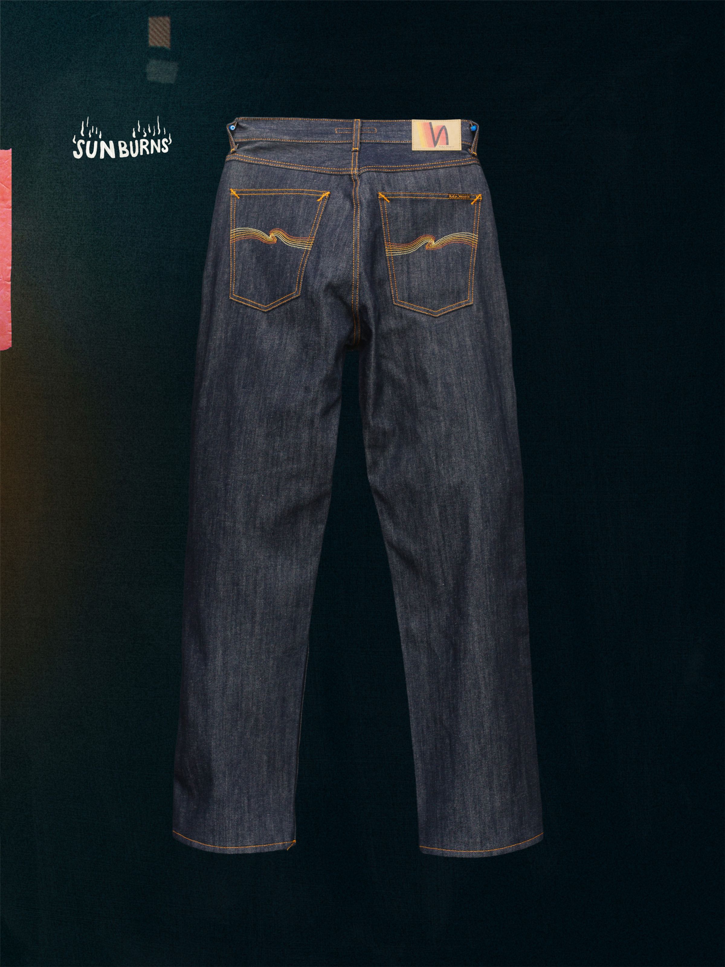 Nudie Jeans Tuff Tony Dry Sunburns, a pair of men's loose fit wide leg jeans in dry denim, shown laid flat from the back.