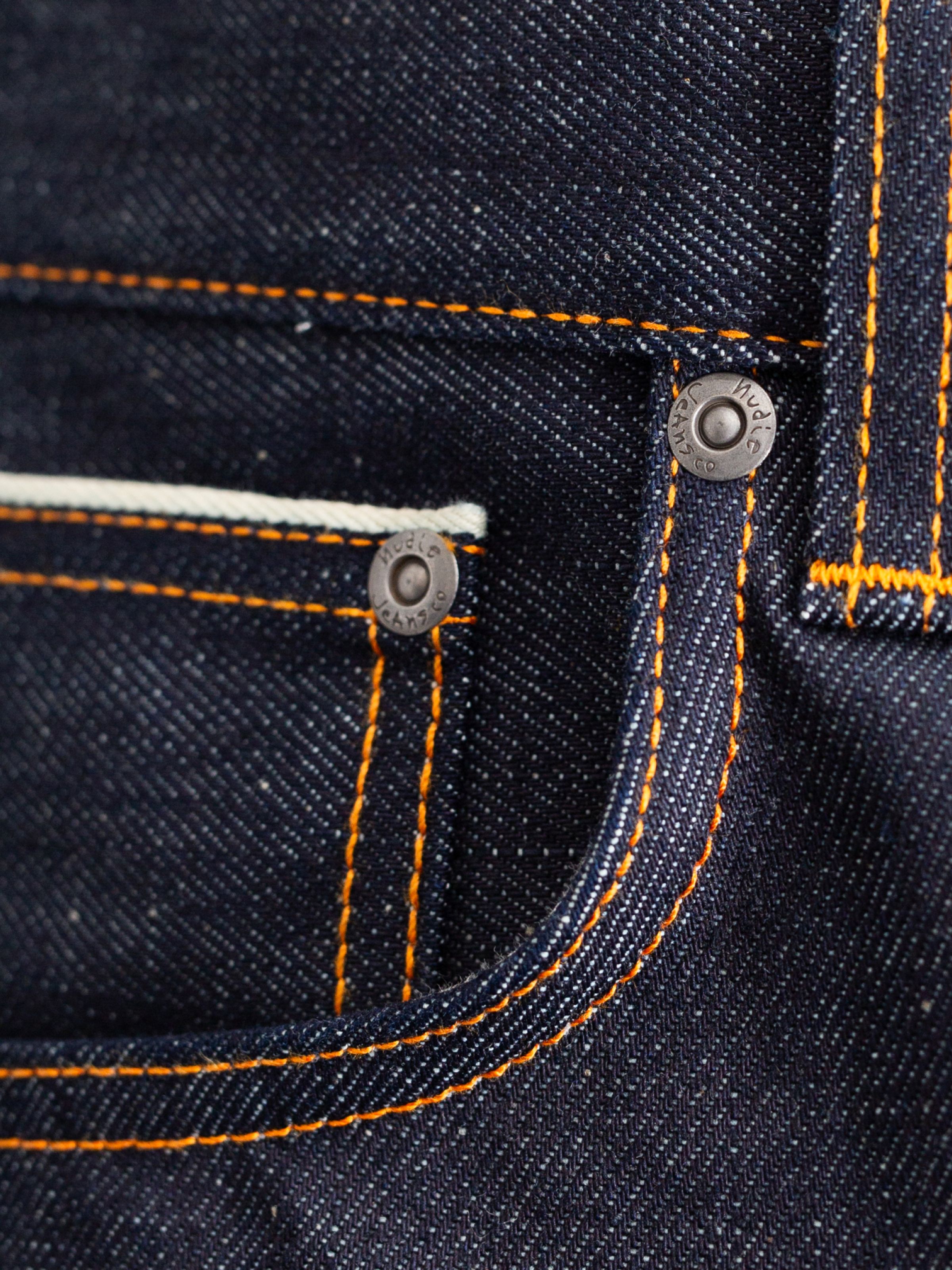 Nudie Jeans Steady Eddie II Dry Dusk Selvage, close-up of the coin pocket showing the selvedge detail and orange stitching.