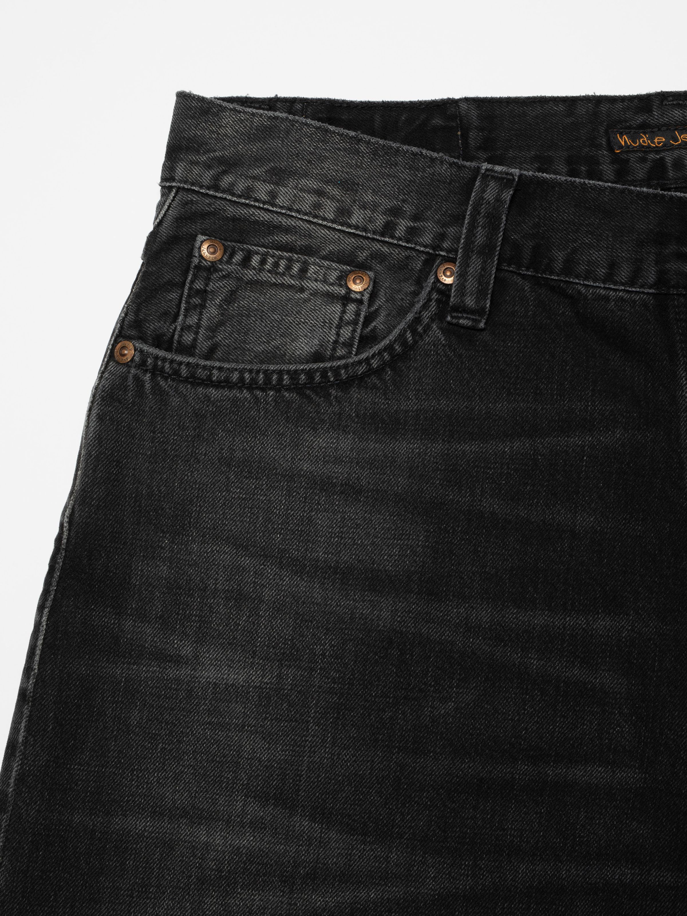 Nudie Jeans Loud Larry Black Storm, a loose fit jean in washed black, with a close-up of the front pocket and denim texture.