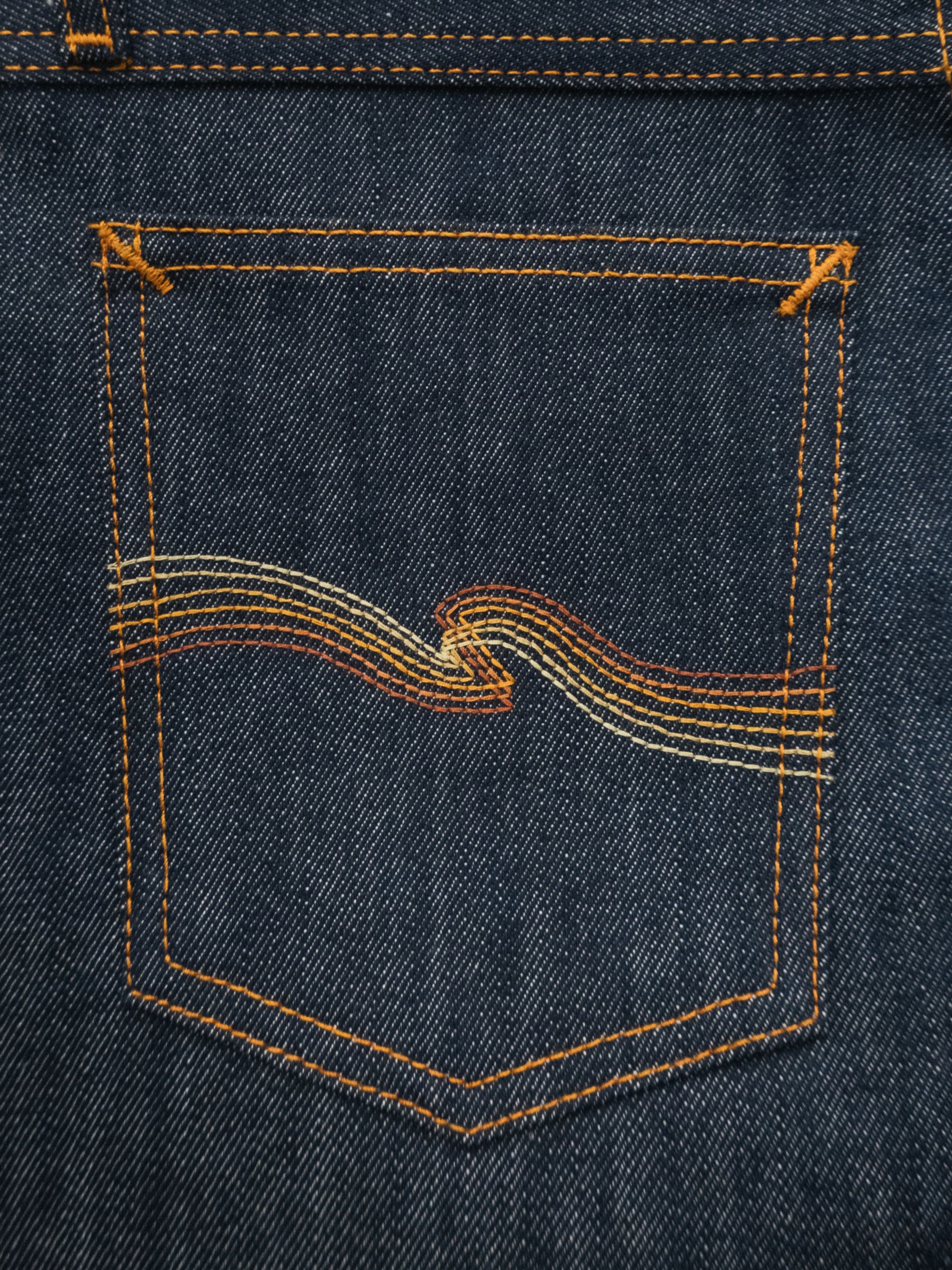 Nudie Jeans Wide Heidi Dry Sunburns, a close-up of the back pocket showing the gradient 'Sunburns' embroidery.
