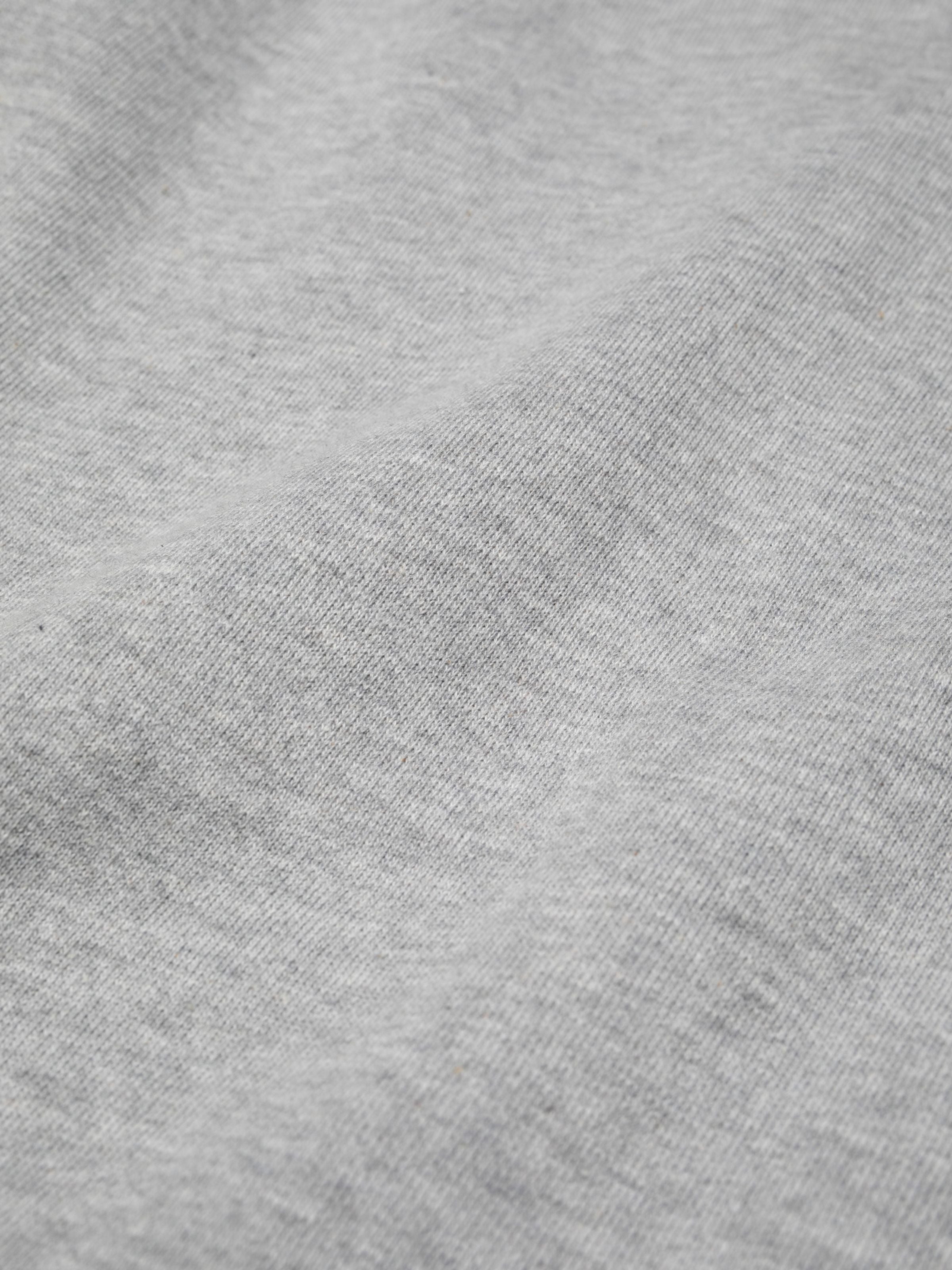 Nudie Jeans Gunde Logo Hoodie in Greymelange, a detailed close-up of the organic cotton jersey fabric.
