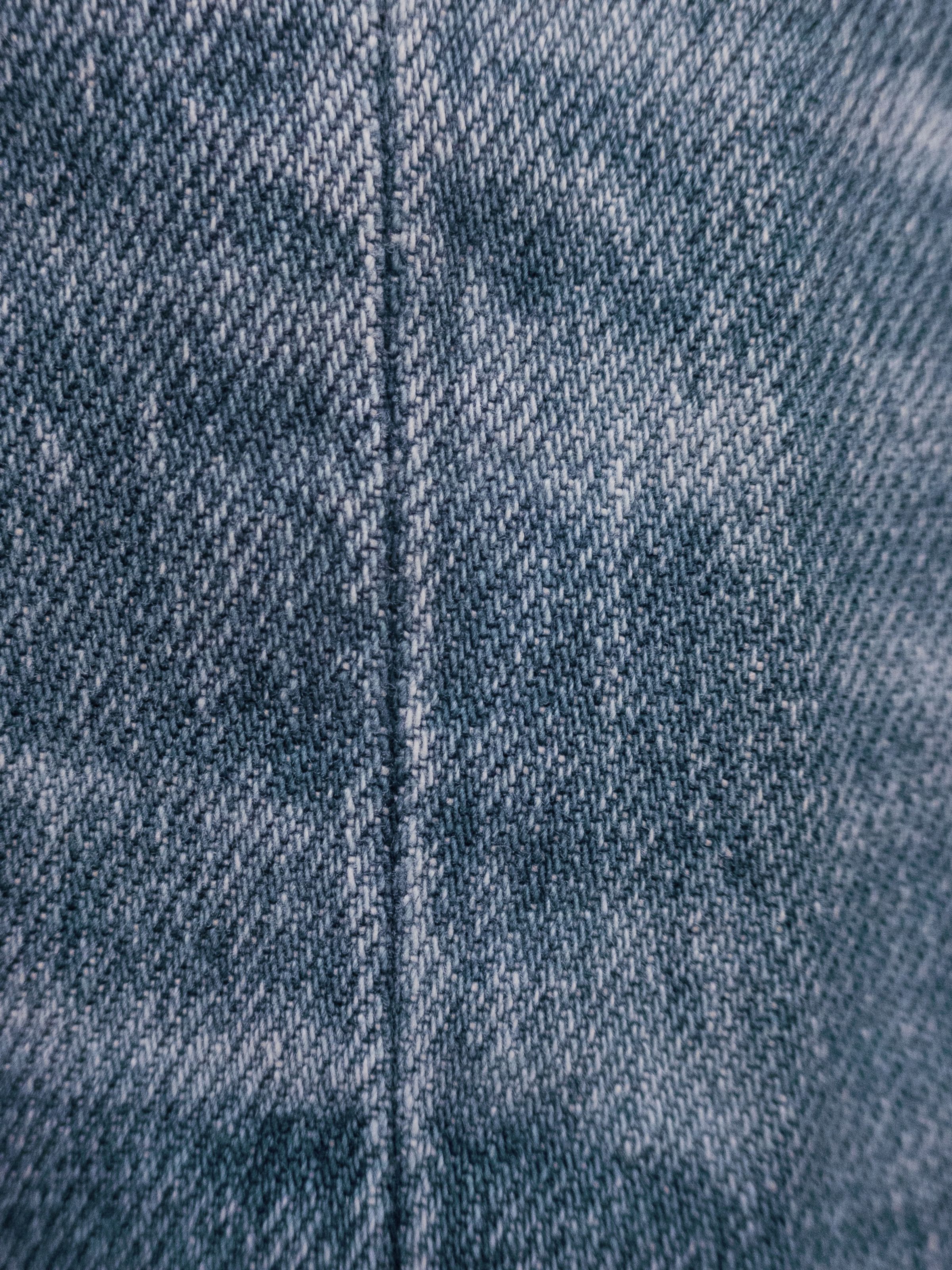 Nudie Jeans Lean Dean Hidden Tracks, close-up of the light blue denim's diagonal weave and salt-and-pepper texture.