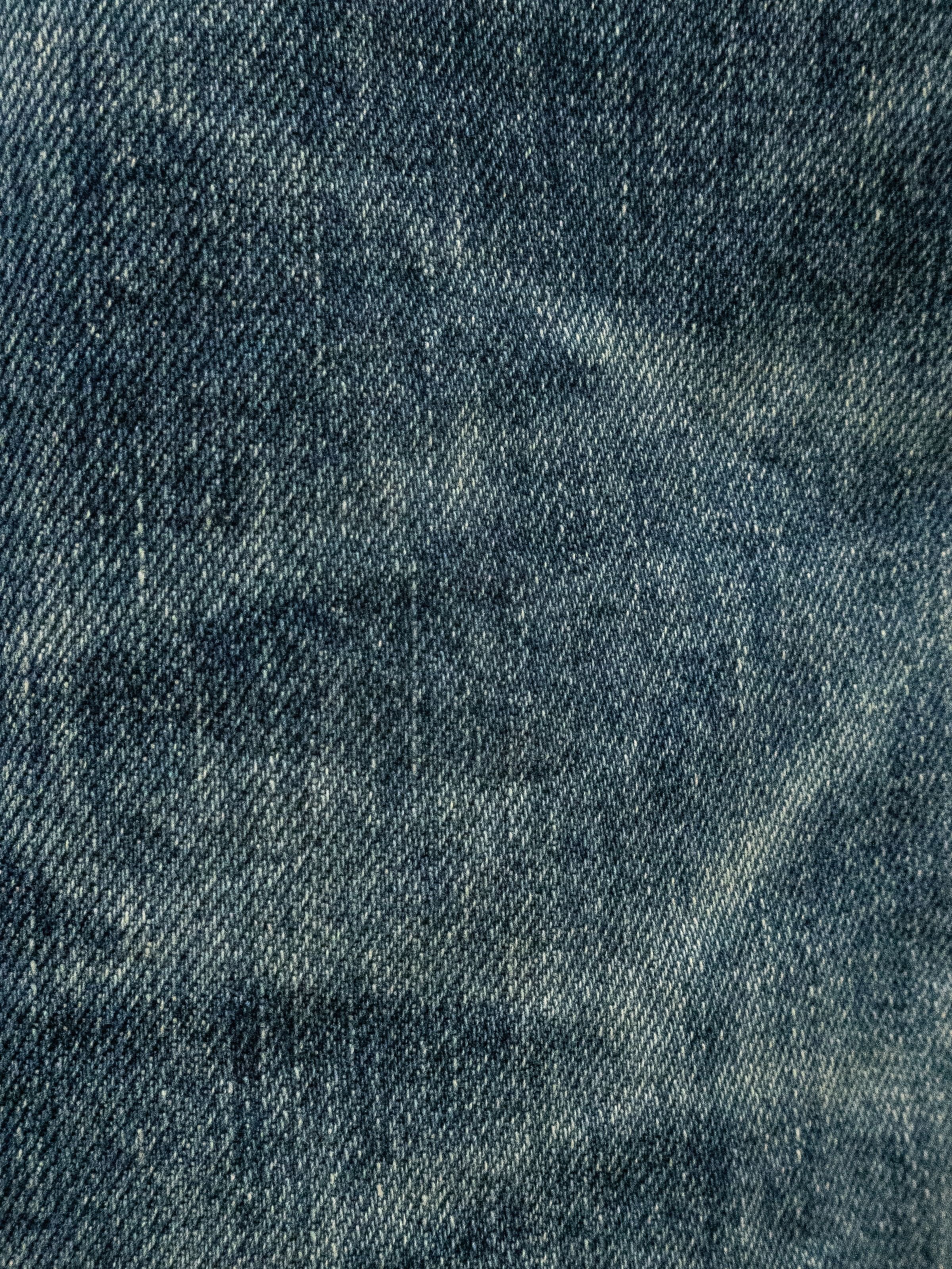 Nudie Jeans Gritty Jackson in Thriller Tracks, a close-up of the mid-blue washed rigid denim fabric.