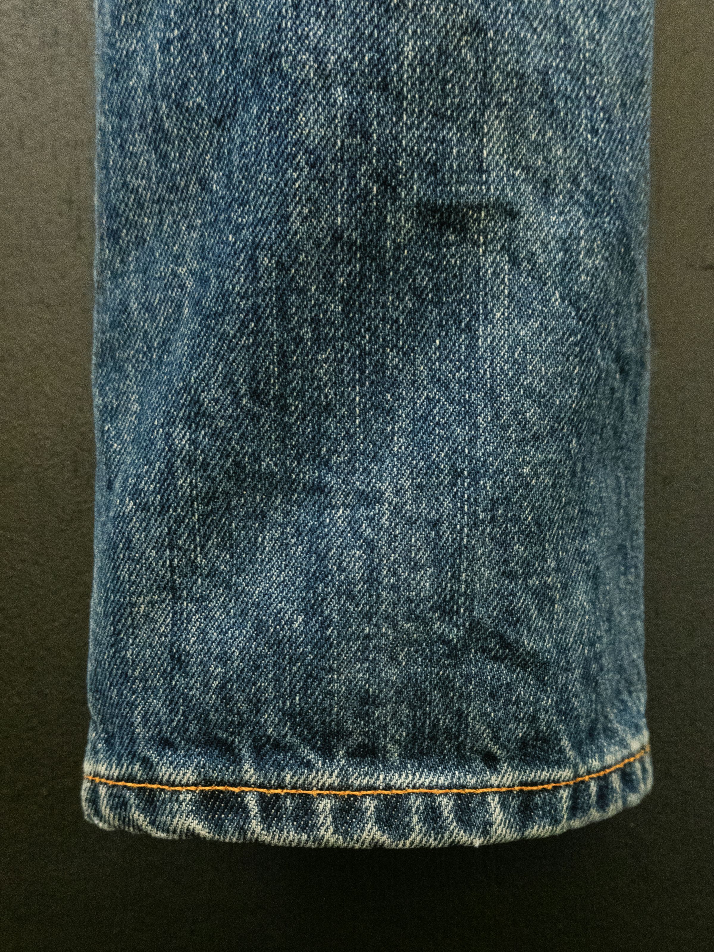 Nudie Jeans Gritty Jackson Thriller Tracks, a close-up of the hem on the men's regular fit jeans.