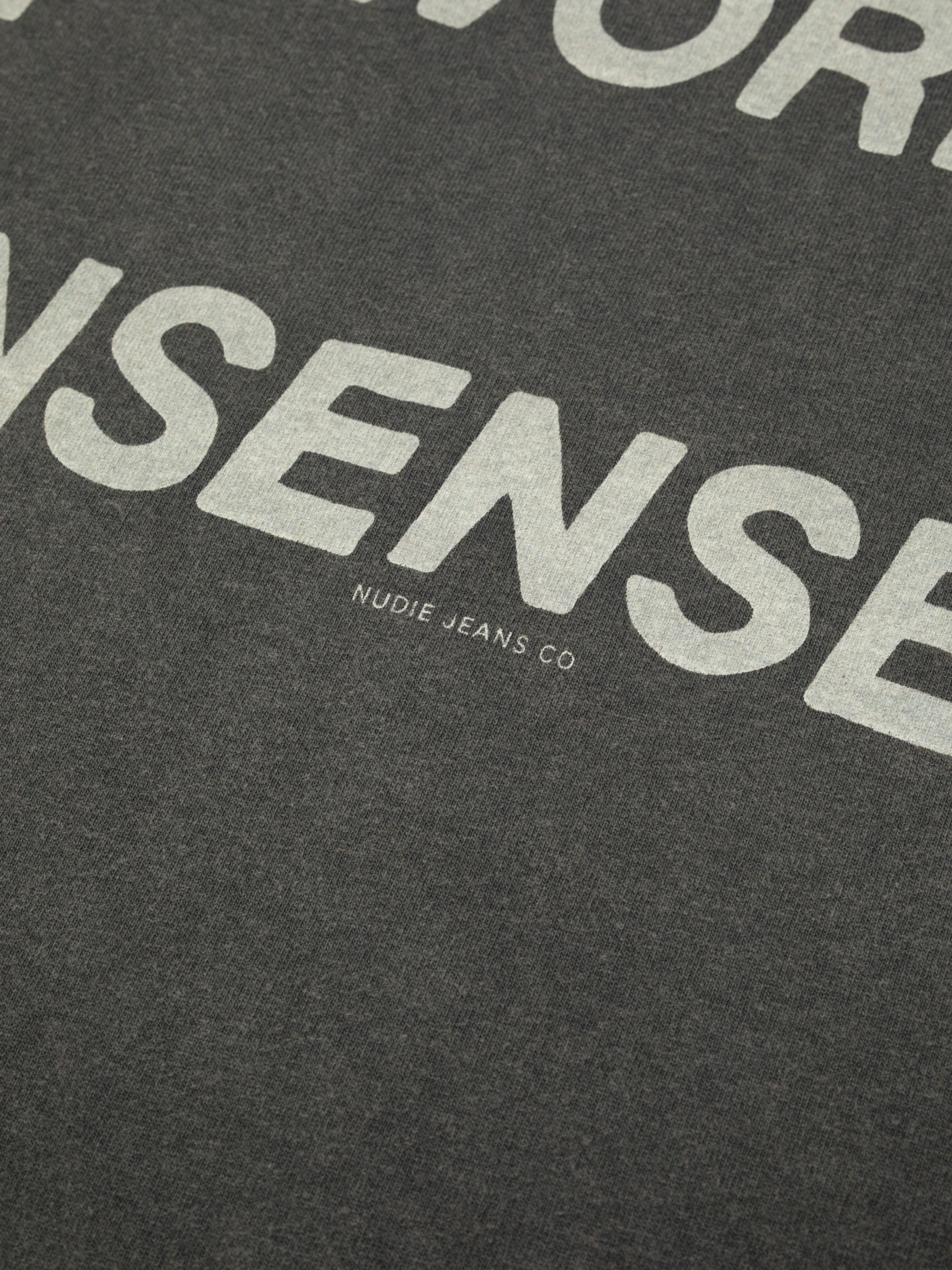 Nudie Jeans Roy T-Shirt Make Sense in Antracite, close-up of the chest print.